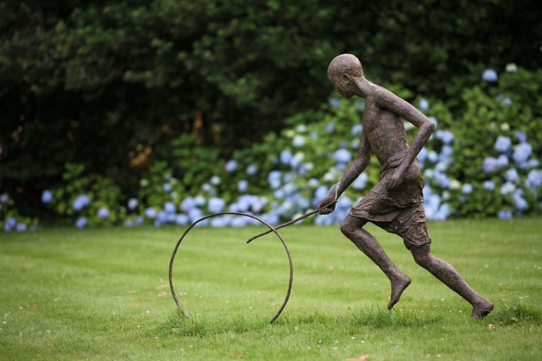 Hoop Rolling Boy is a large-scale sculpture by French contemporary artist Marine de Soos.  Bronze, 128 cm × 162 cm × 29 cm. Limited edition of 8 copies and IV artist’s proofs.
Each of Marine de Soos' sculptures has its story, being a memory of a