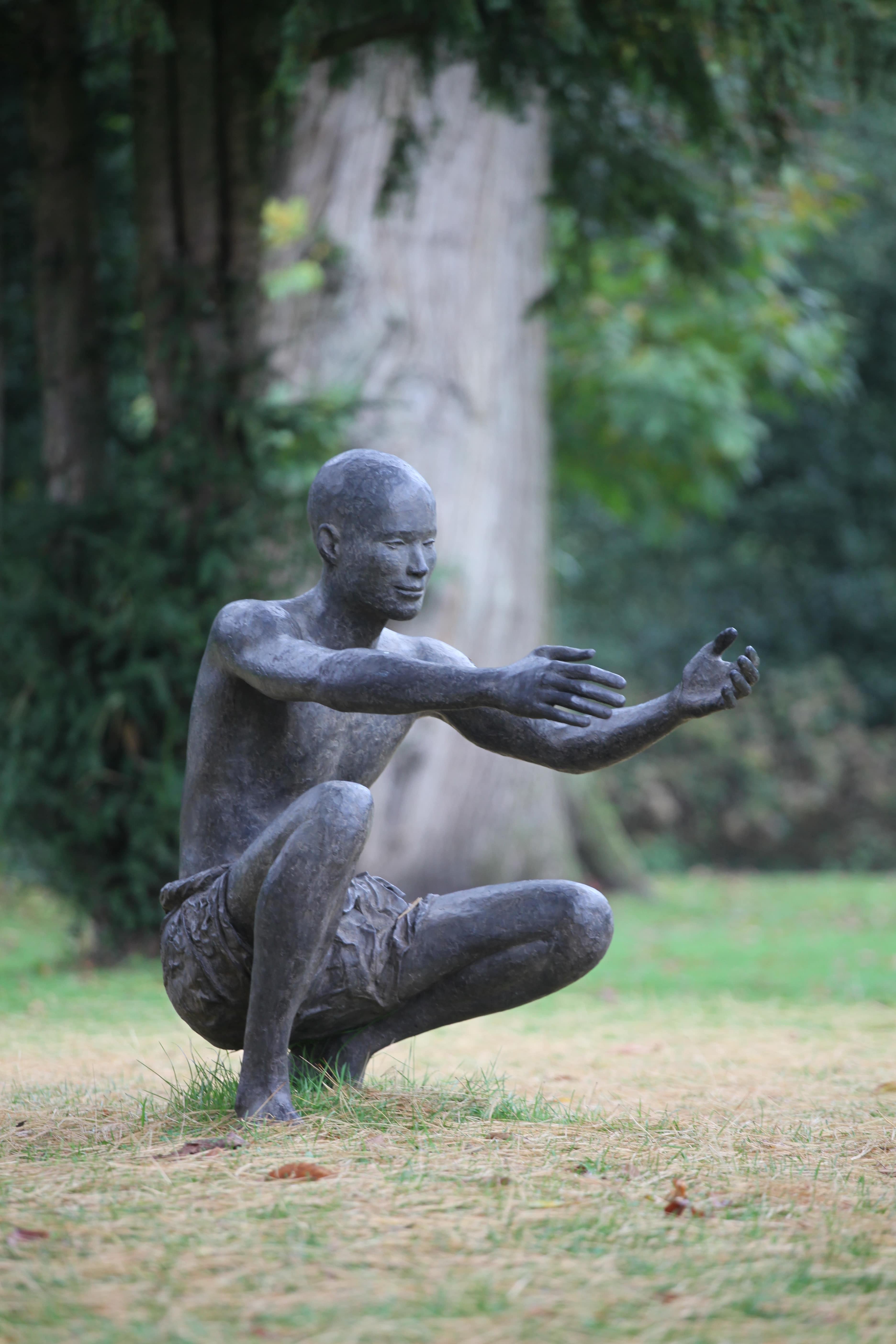 The Welcome by Marine de Soos - Outdoor bronze sculpture, squatting male figure For Sale 1