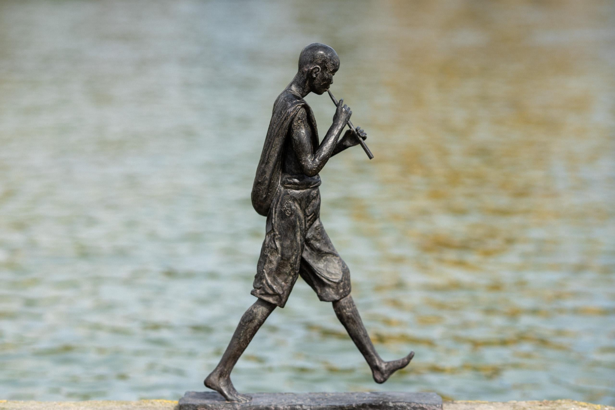 Young Flute Player is a bronze sculpture by French contemporary artist Marine de Soos, dimensions are 51 × 12.5 × 37 cm (20.1 × 4.9 × 14.6 in). 
The sculpture is signed and numbered, it is part of a limited edition of 8 editions + 4 artist’s proofs,
