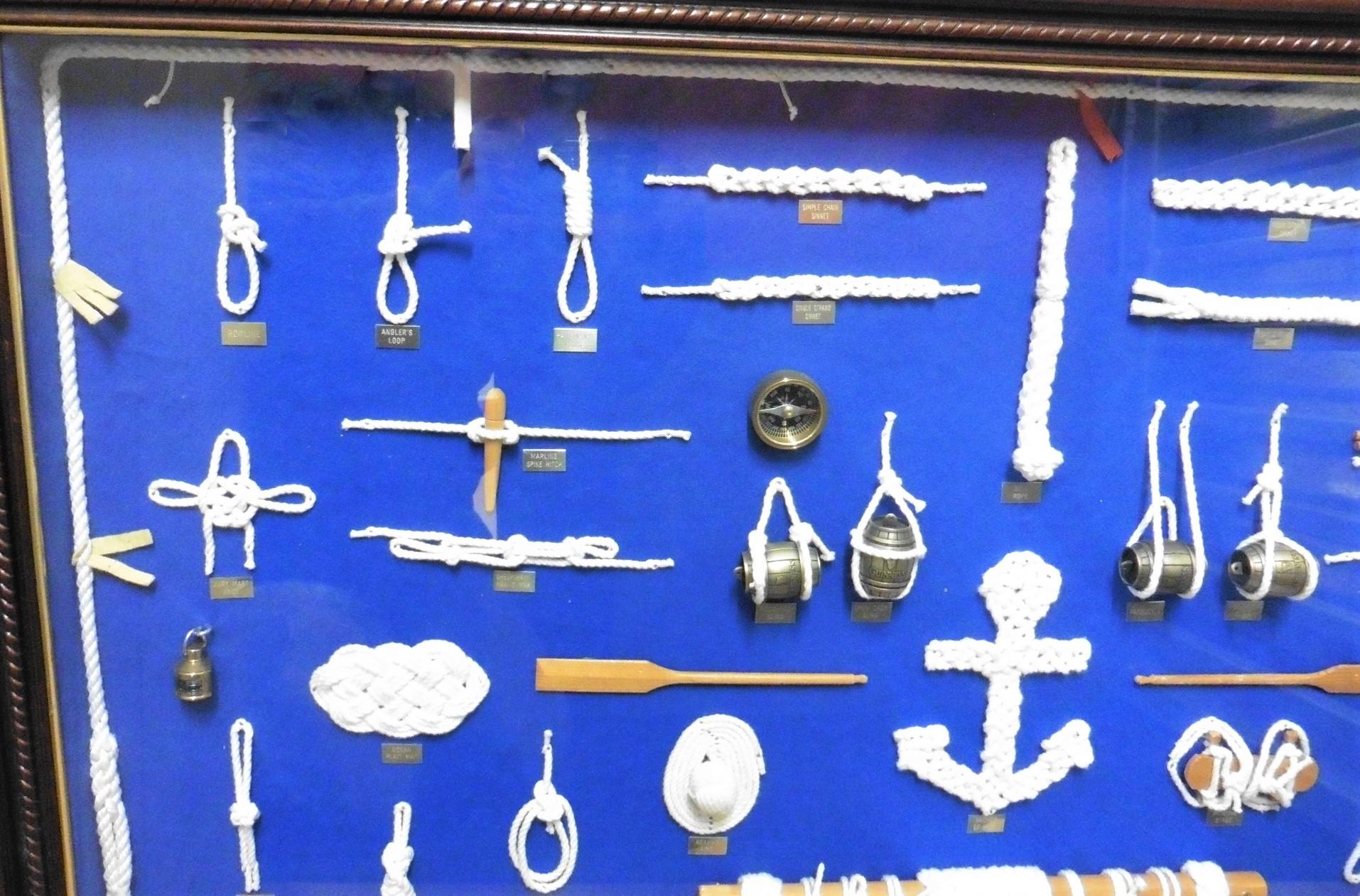 Marine Knot board by Captain D.J.Walker


A fine example of a marine specimen board with a 'mahogany' surround. Samples of numerous marine knots, sextant, binnacle, compass, oars, plumb lines, ships wheel, telescope etc. All mounted on a blue