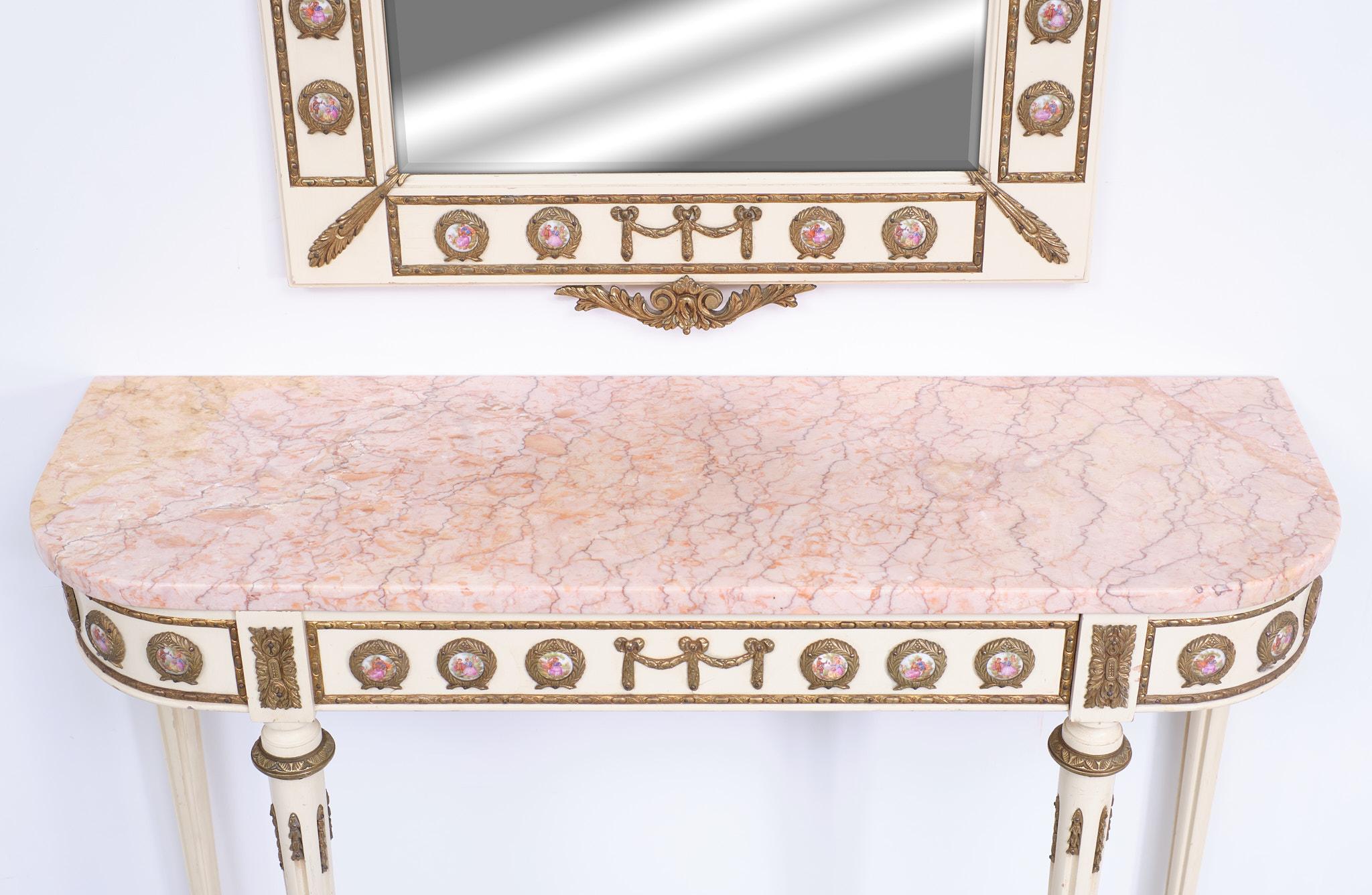 This is an beathiful elegant French Louis XVI Revival console table and matching mirror dating from the Mid-20th Century. Made by Mariner SA Spain top quality. 
This magnificent piece is crafted from wood with stunning ormolu mounts and features