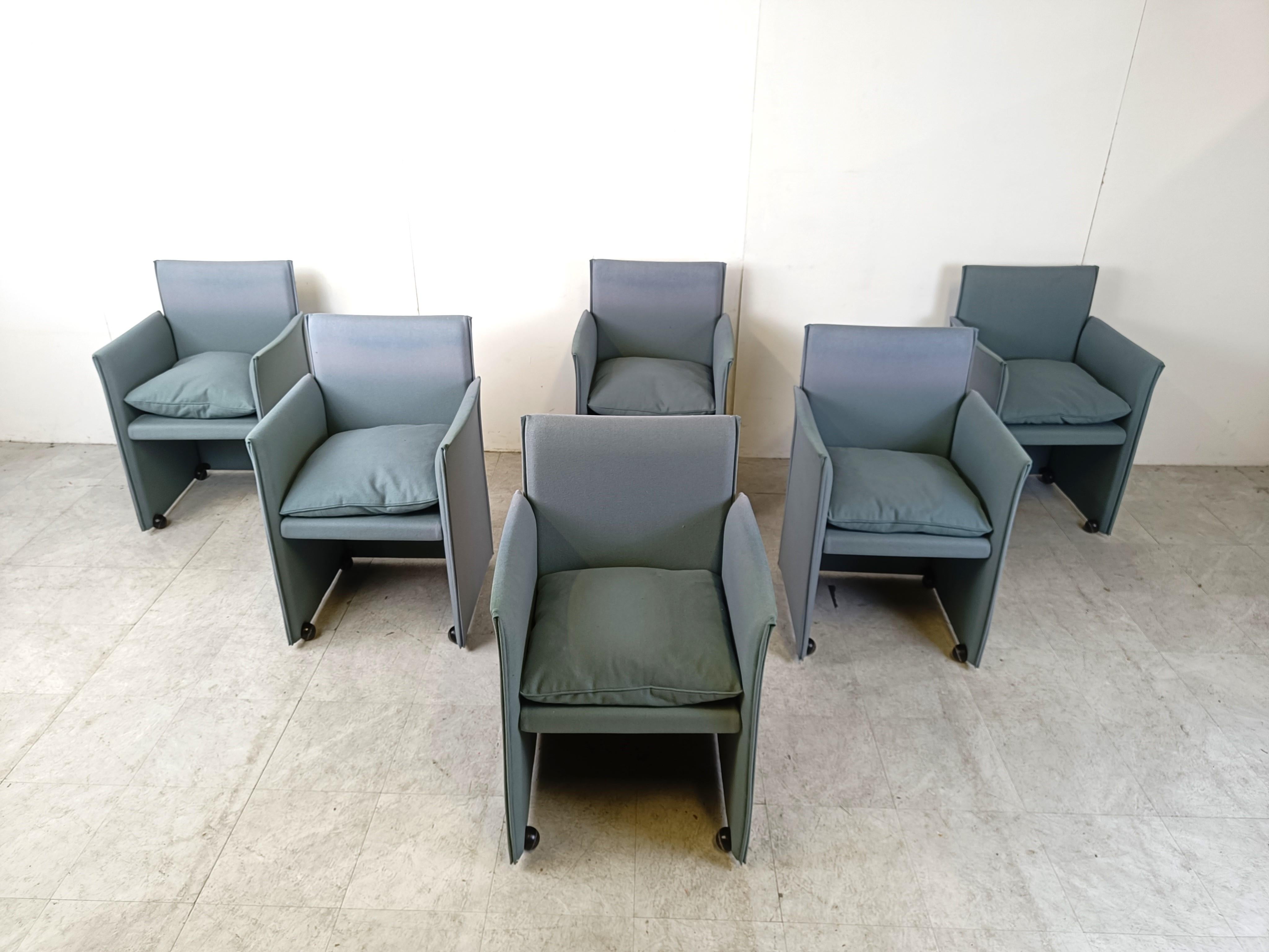 Blue fabric 401 break chairs designed by Mario Bellini and produced by Cassina.

The chairs have 4 casters which make them glide smoothly and are well integrated in the design.

1990s - Italy

Good condition, the colour is slightly faded but still
