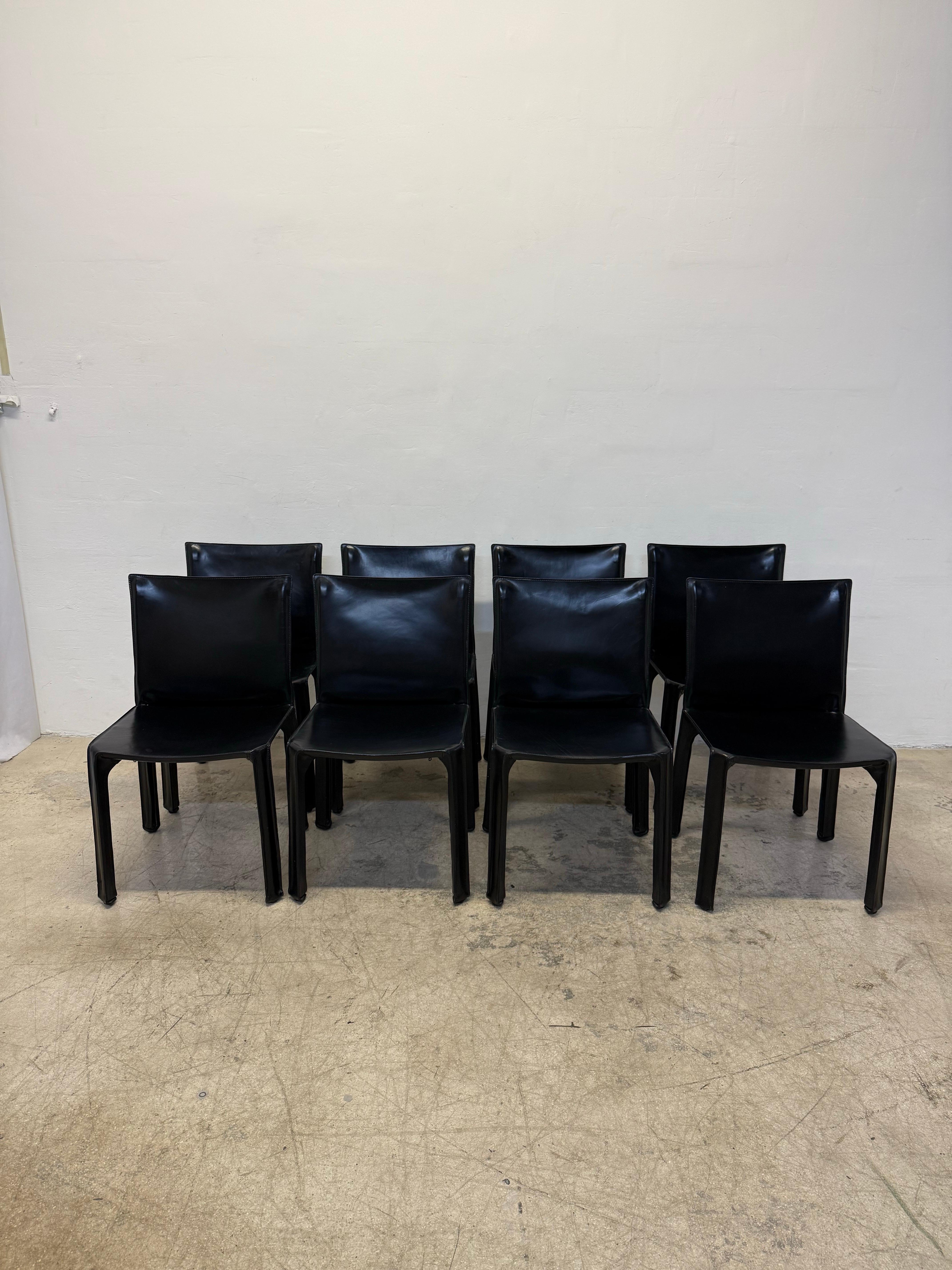 Conjunto de ocho sillas de comedor o auxiliares CAB 413 de cuero negro de primera producción, diseñadas por Mario Bellini para Cassina. Italia, años 70.  Todas las sillas mantienen las etiquetas Cassina.

