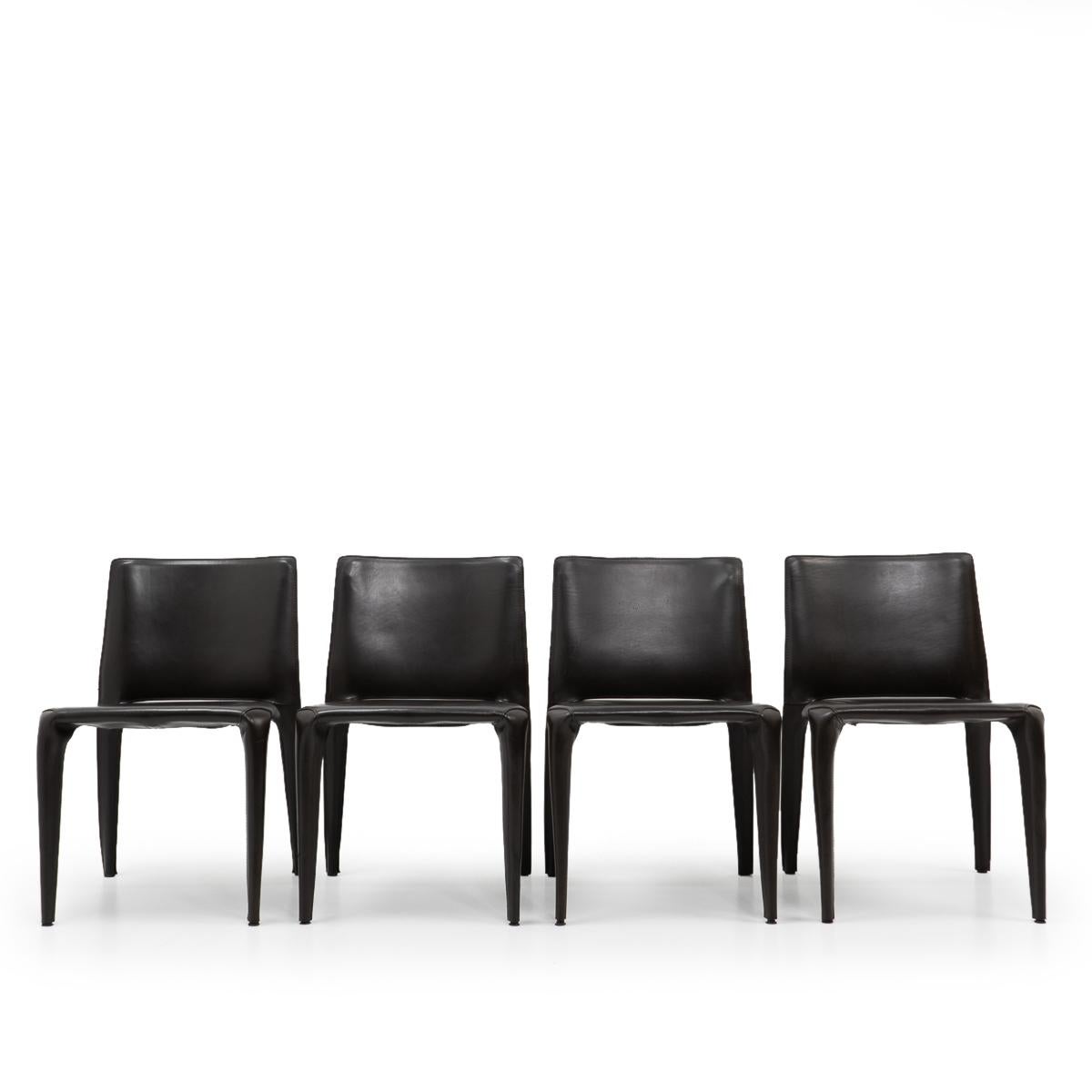 Set of four Bull dining chairs in dark BROWN leather by Mario Bellini for Cassina.

The Bull chair is built up as a tubular frame over which thick saddle leather is fitted; the leather skin is kept in place with zippers on the inside legs, very much