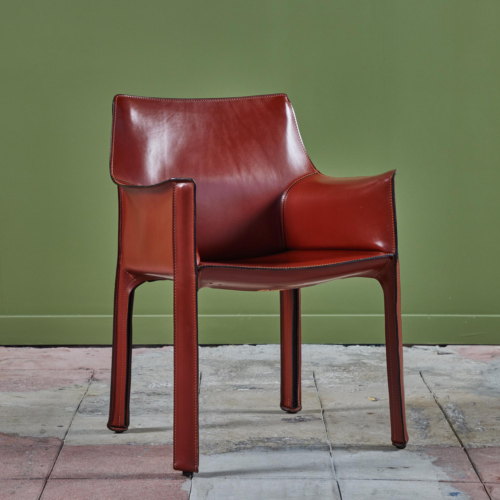 This iconic chair designed by Mario Bellini for Cassina c.1970s, Italy, features the original deep red saddle leather which is wrapped atop a steel frame. The back legs feature a black zippered detail. The chair can easily be used for dining or an