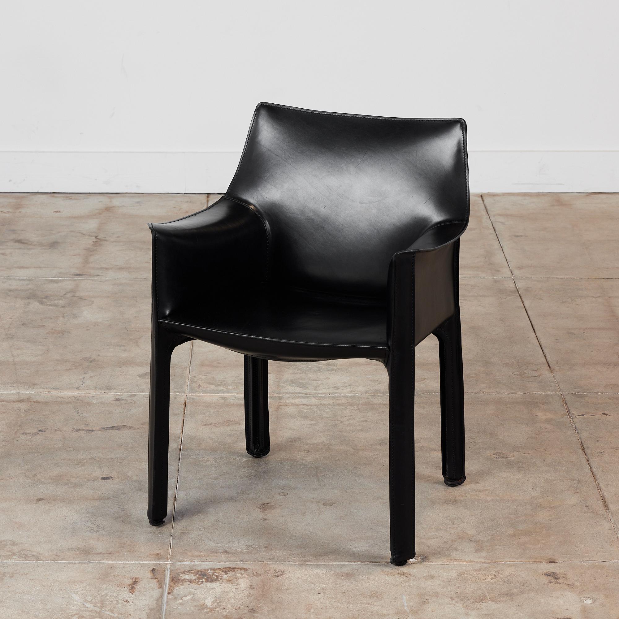 This iconic chair designed by Mario Bellini for Cassina c.1970s, Italy, features the original black saddle leather which is wrapped atop a steel frame. The back legs feature a black zippered detail. The chair can easily be used for dining or an
