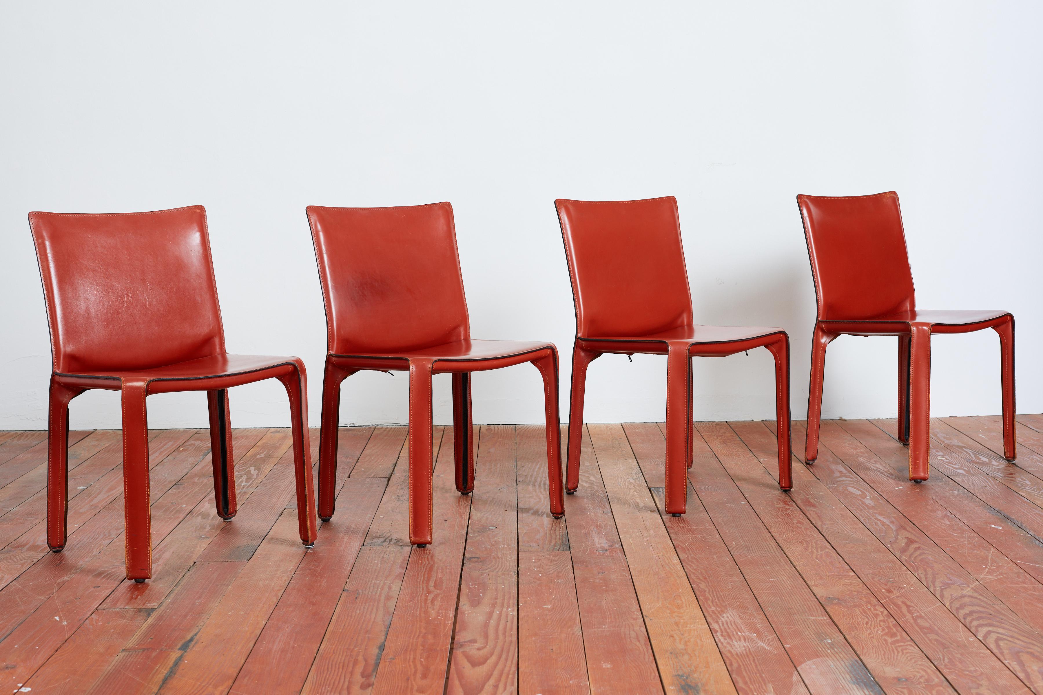 Classic leather cab chairs by Mario Bellini for Cassina in cognac reddish leather. 
Wonderful patina. 
Set of four available. Priced individually.
