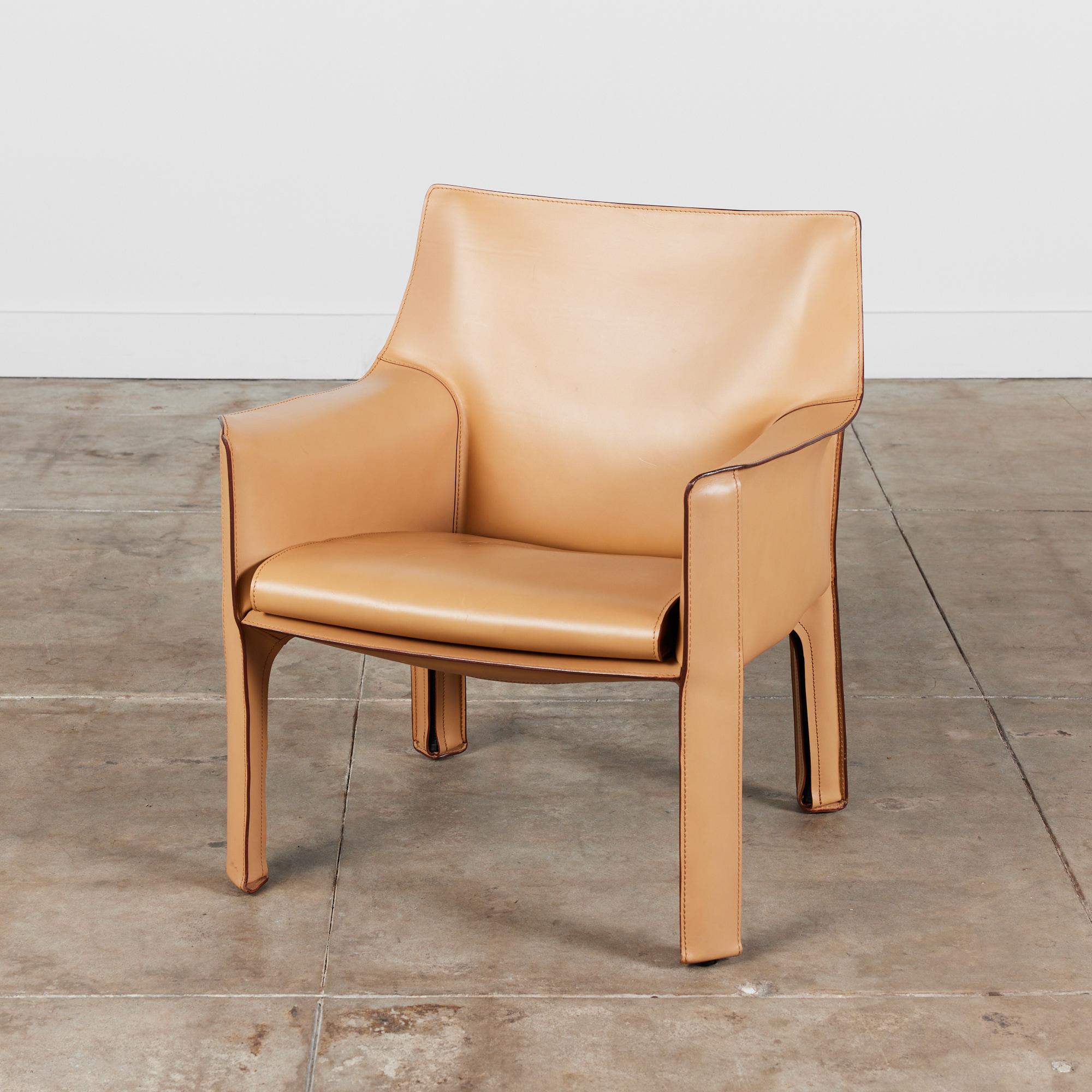 This iconic chair designed by Mario Bellini for Cassina circa 1970s, Italy, features the original natural toned saddle leather which is wrapped atop a steel frame. The seat has a rounded leather curved seat cushion with stitched detailing. The legs