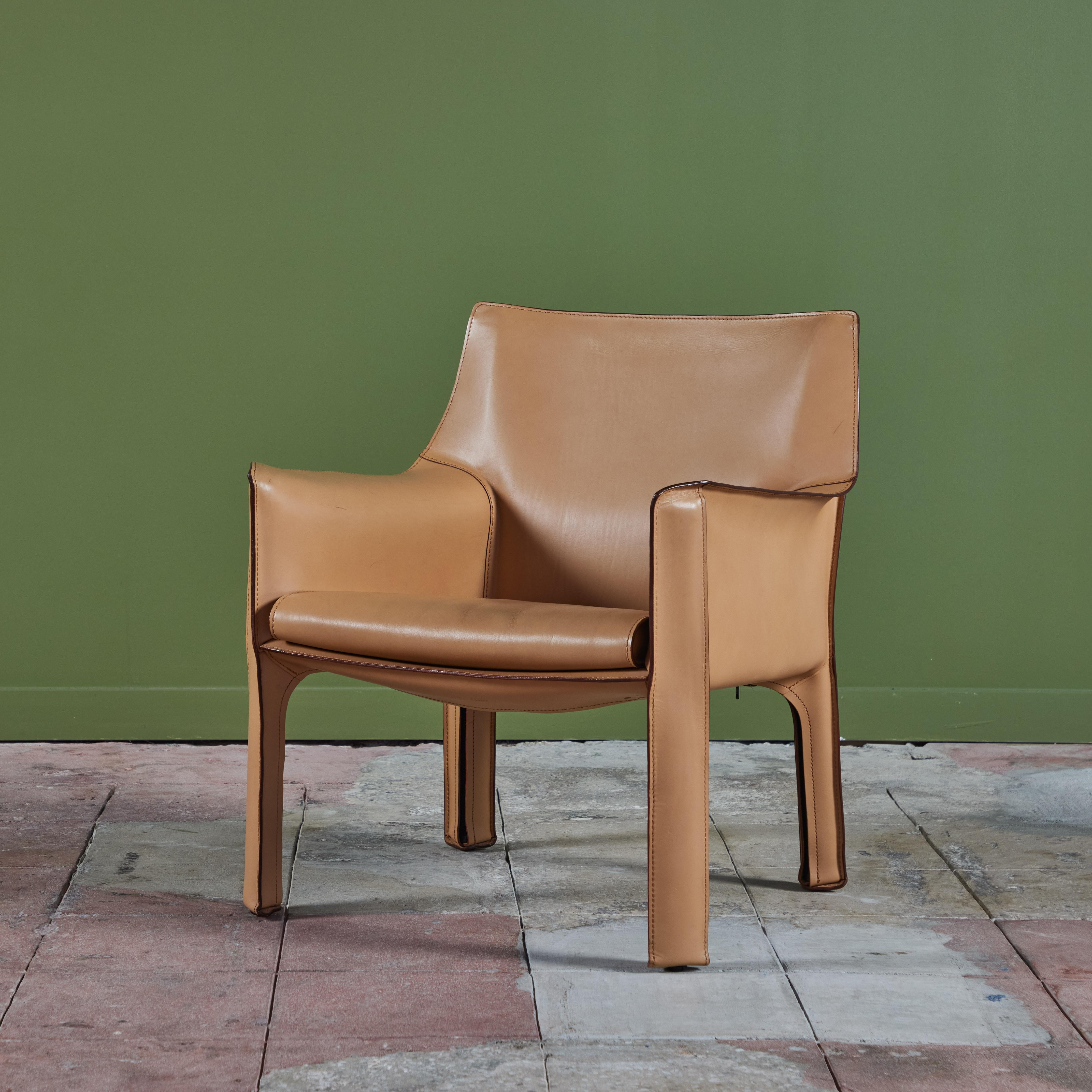 This iconic chair designed by Mario Bellini for Cassina c.1970s, Italy, features the original natural toned saddle leather which is wrapped atop a steel frame. The seat has a rounded leather curved seat cushion with stitched detailing. The legs