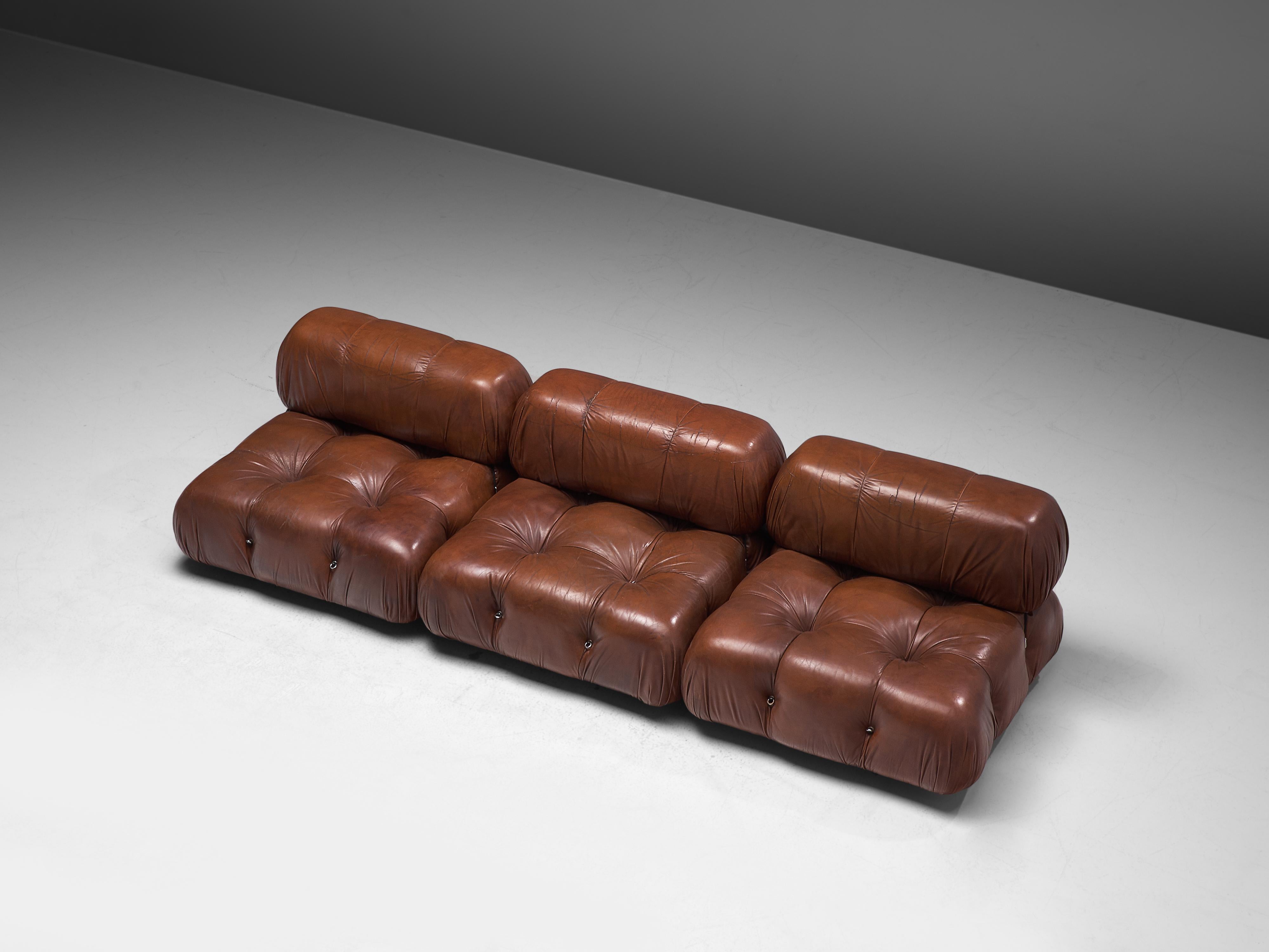 Mario Bellini, modular 'Cameleonda' sofa, brown leather, Italy, designed in 1972.

The sectional elements of this sofa can be used freely and apart from one another. The backs and armrests are provided with rings and carabiners, which allows the