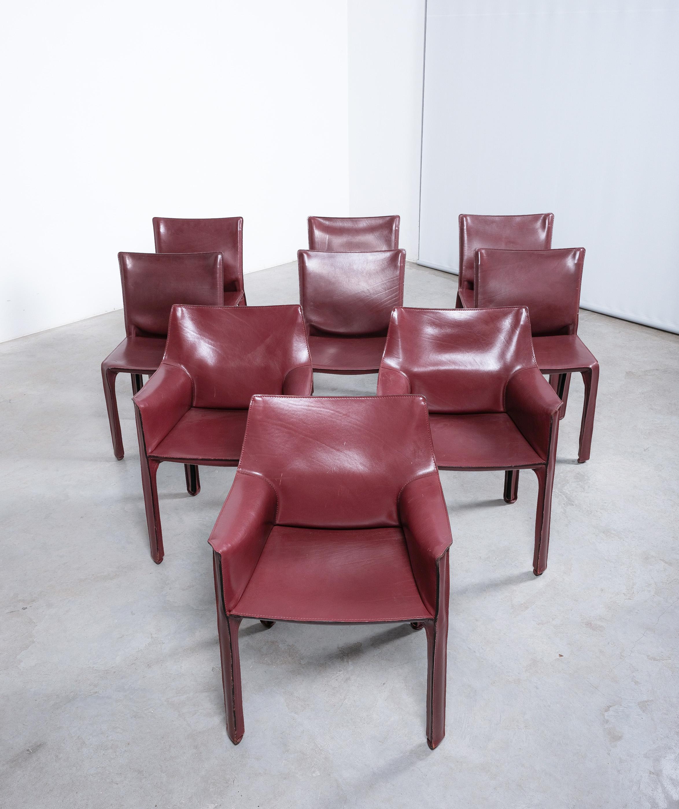 Set of nine original vintage cab 412 (6 pieces) and 413 (3 pieces) by Mario Bellini for Cassina in very good vintage condition. 
A nice set of Italian design icons in red burgundy (oxblood) saddle leather. Consisting of 3x captain chairs cab 413 and