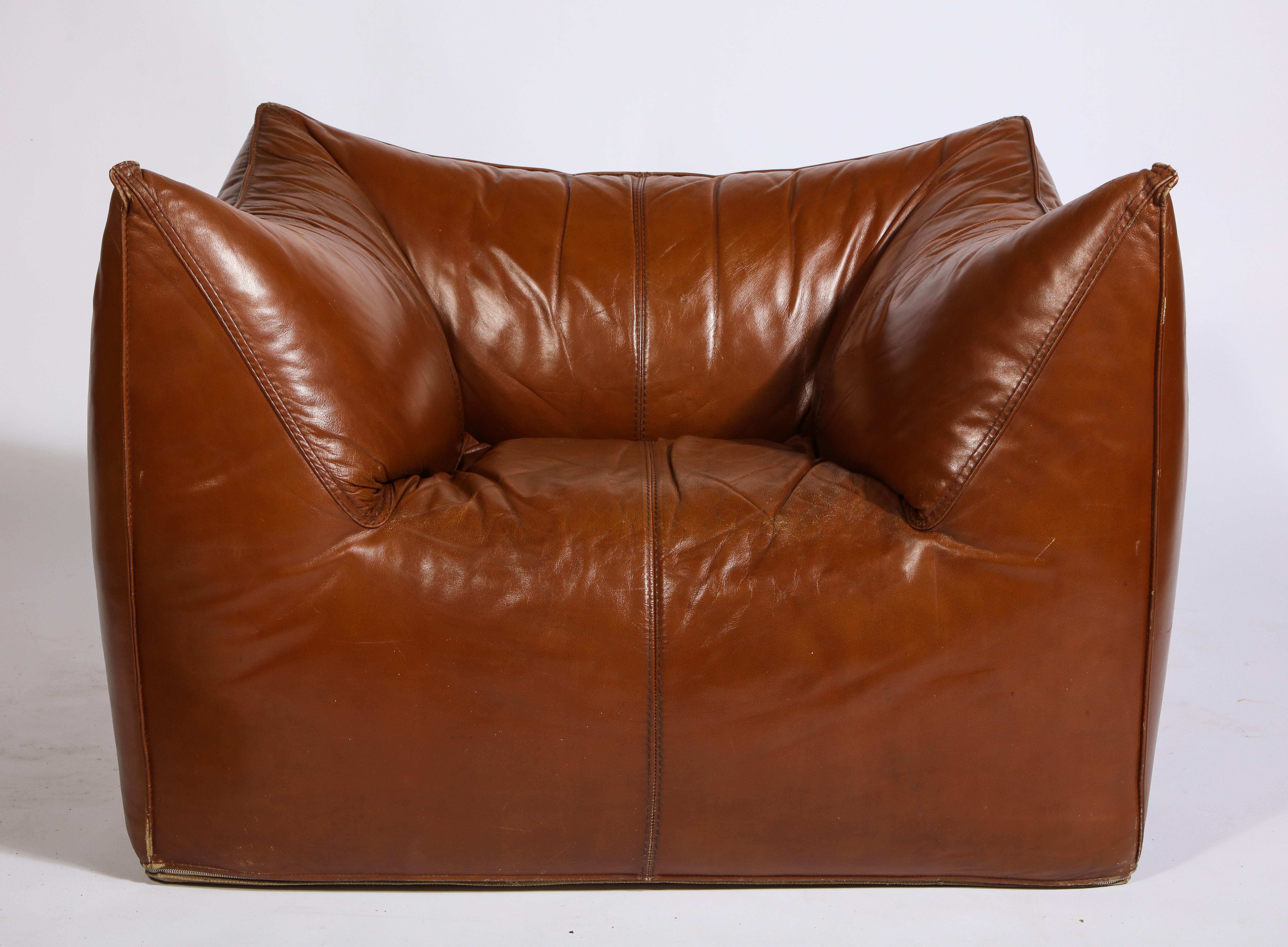 Mario Bellini Cognac brown leather chair and ottoman Bambole set, Italy. 

Sofa set, beautiful deep cognac color. Beautiful vintage condition, Italy, 1970s.
Actual color less red and more brown/rust as shown in the third photo

Measures: 

Chair
30