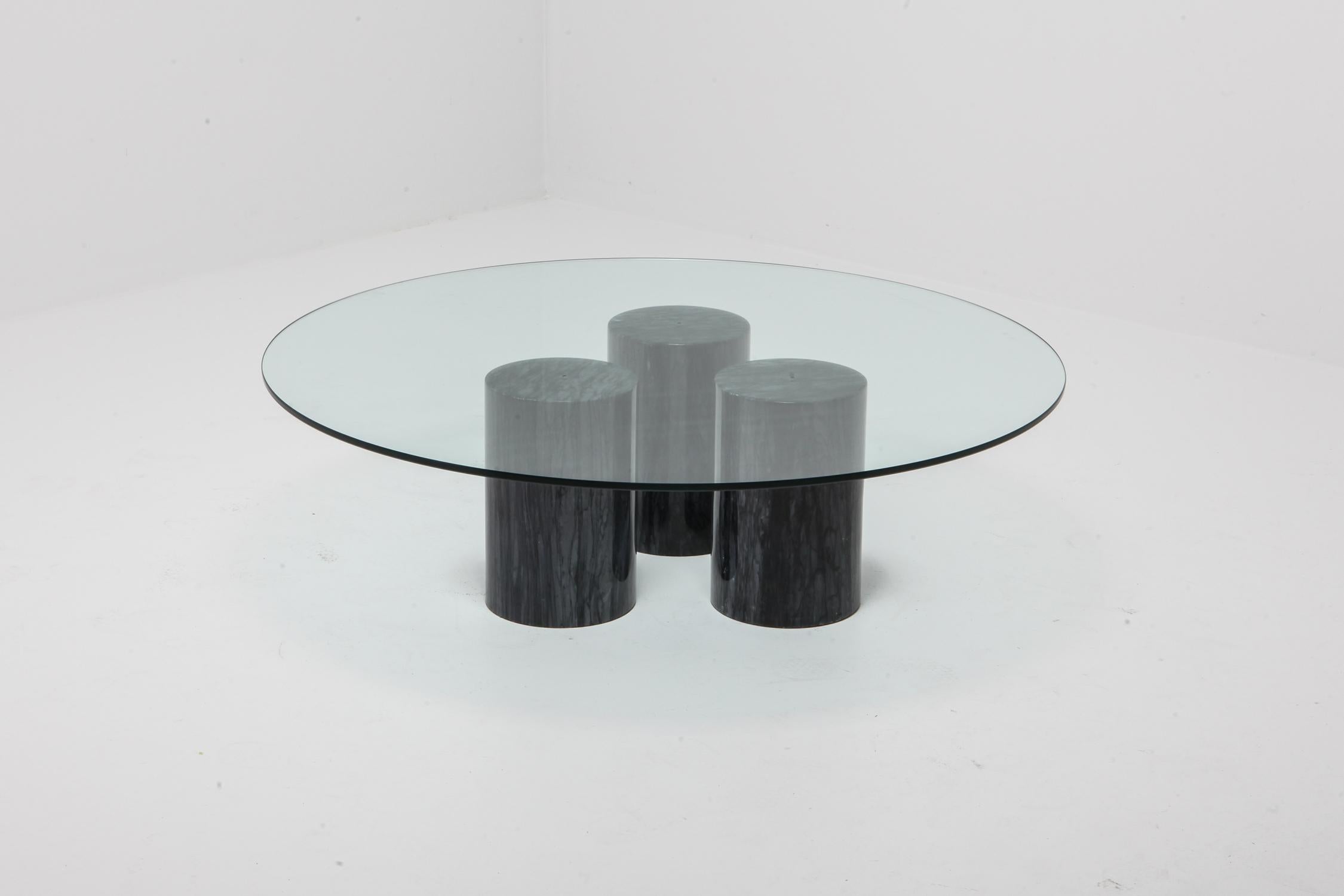 Post-modern cocktail table by Mario Bellini
Three black marble columns support a round glass top.
As the marble columns can be positioned in various ways, we could provide a custom made tabletop.
reach out with any questions.