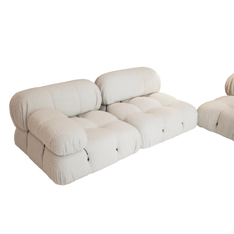 Camaleonda modular sofa designed by Mario Bellini (1935-) for B&B Italia in 1972. Composed of 3 large modular seats with backrest, 3 small modular seats with backrest, 2 armrests and 1 shoe remover. White bouclé wool upholstery.

Big modules