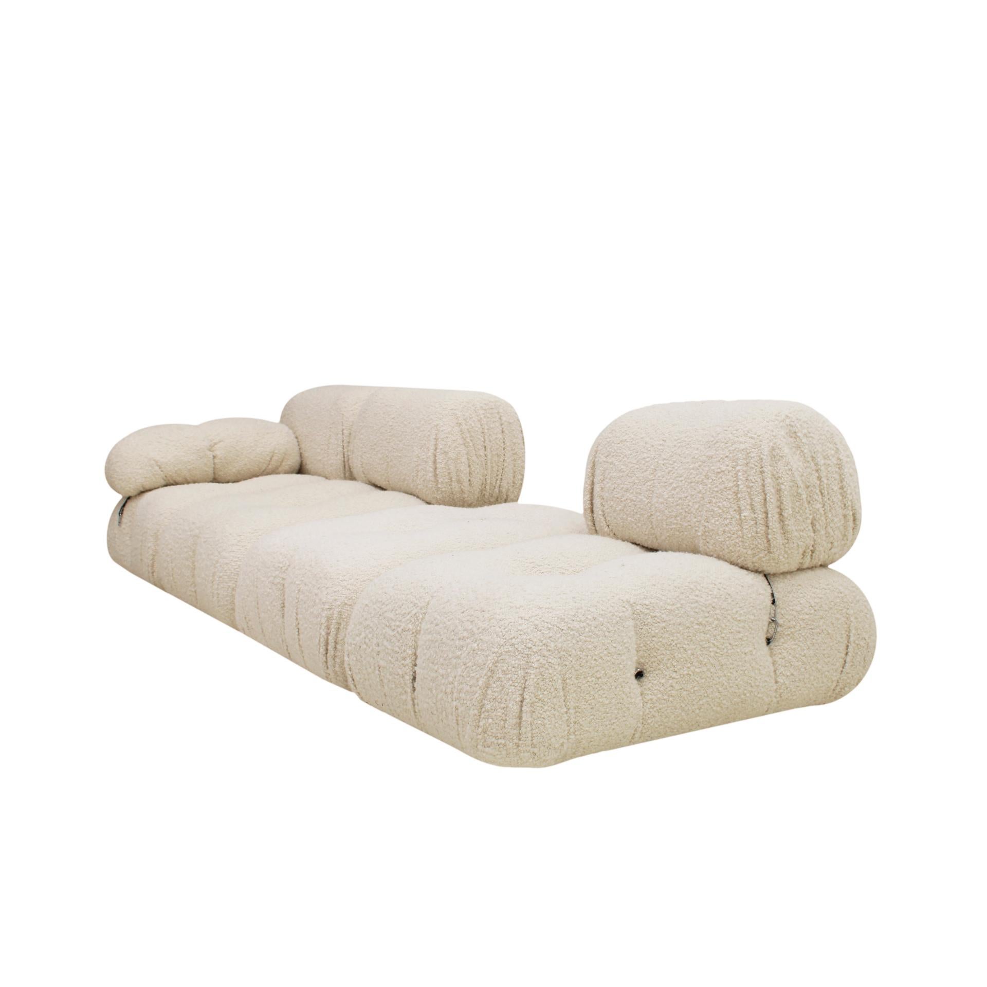 Camaleonda modular sofa designed by Mario Bellini (1935-) for B&B Italia in 1972. Composed of large modular seats with backrest, 3 small modular seats with backrest, 1 armrest and 1 shoe remover. White bouclé wool upholstery.

Modules