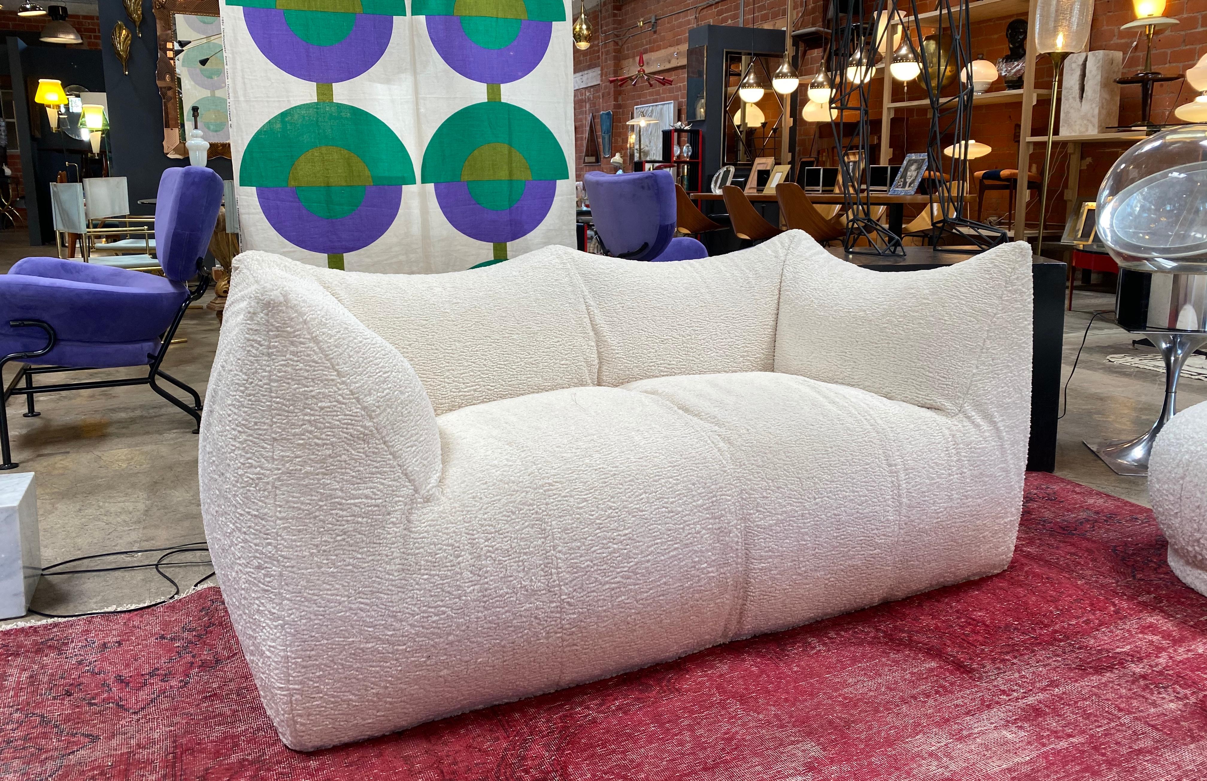 Mario Bellini for B&B Italia, 'Le Bambole' sofa, brown leather, Italy, 1972.

This comfortable white sheep rehupolstored fabric settee is bulky and playful, shaped as if it is merely a large cushion and the accompanying feeling is the same. It is