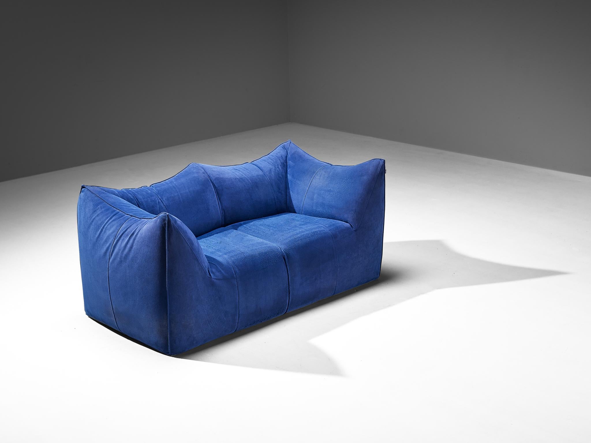 Mario Bellini for B&B Italia, 'Le Bambole' sofa, suede, Italy, 1972. 

This comfortable sofa executed in blue suede is bulky and playful, shaped as if it were merely a large cushion and the accompanying feeling is the same. It is designed by Mario