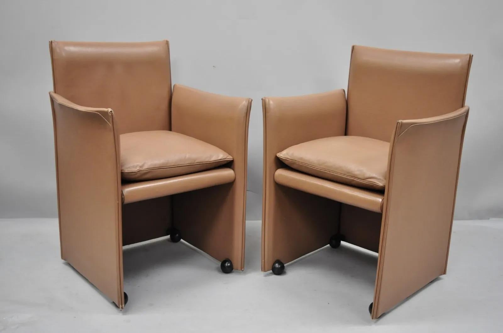 Mario Bellini for Cassina 401 Break Armchair Copper Leather Dining Chair - a Pair. Item features full leather wrapped frames, rolling casters, original label, clean modernist lines, sleek sculptural form. Circa Late 20th Century. Measurements: 33