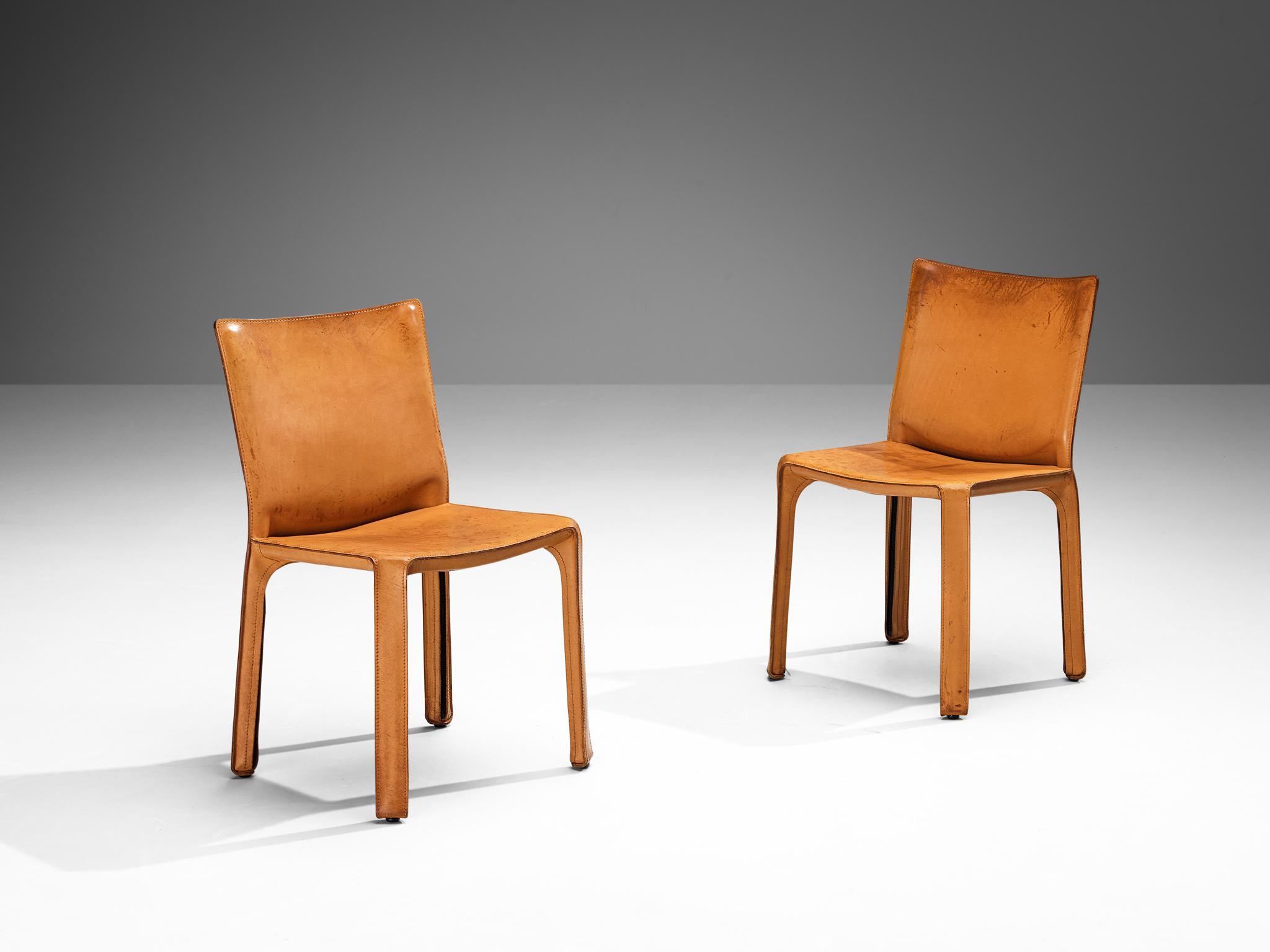 Mario Bellini for Cassina, pair of 'cab' dining chairs, model 412, cognac leather, steel, Italy, 1976

Beautiful pair of dining chairs executed in patinated cognac leather designed by Mario Bellini for Cassina. Conceptually, the chair was designed