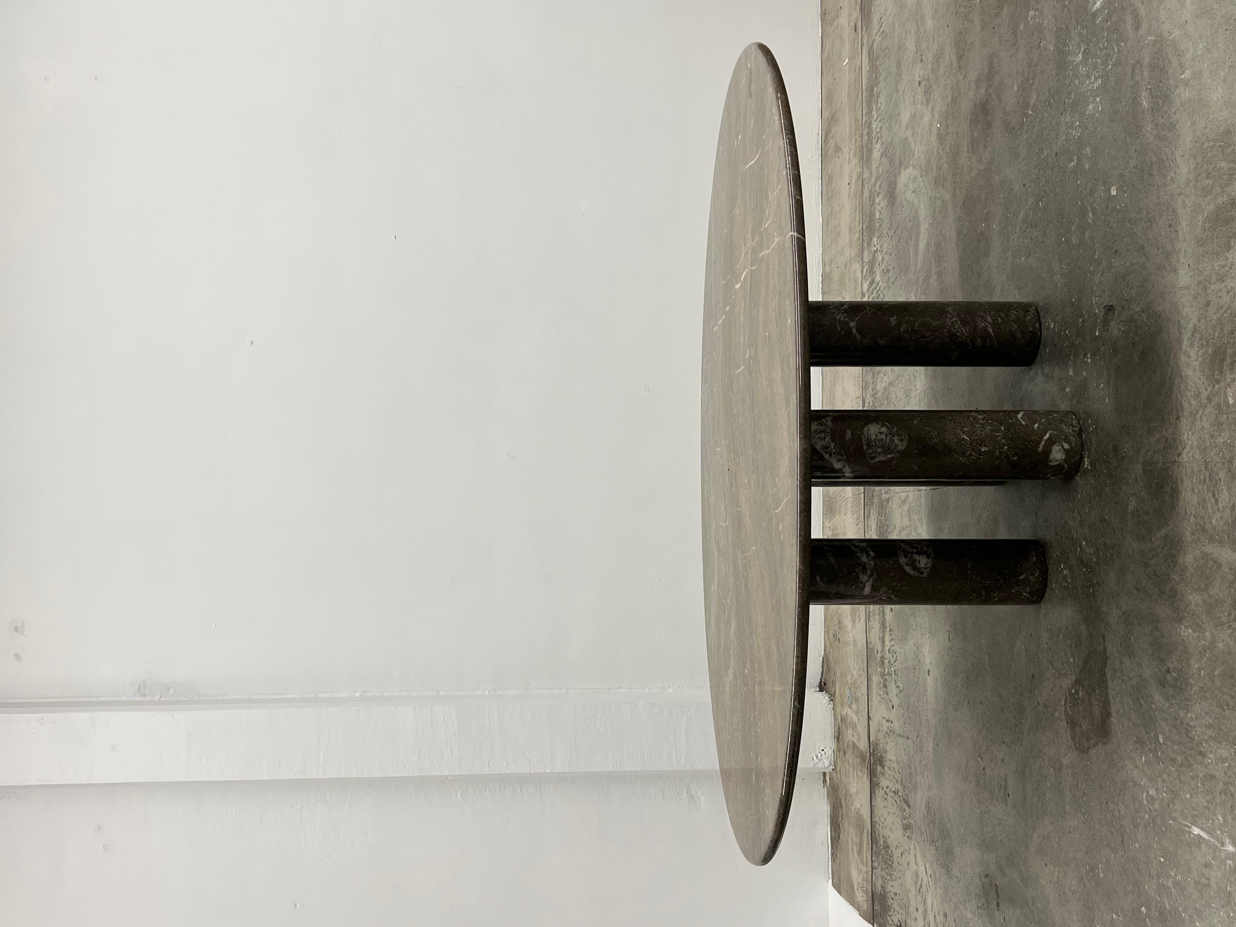 Mario Bellini grey marble Il Colonnato oval table. 

Milanese architect Mario Bellini is well known for creating monumental and conceptual pieces of design, such as the Camaleonda sofa (1971) and Le Bambole. His distinctive architecture and design
