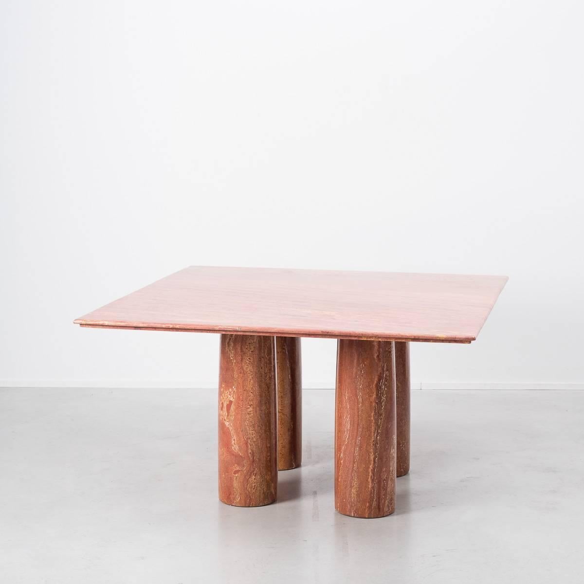 This stunning minimalist table designed by Milanese architect Mario Bellini is made purely from one material, solid red travertine marble. A square top with a reversed step edge profile sits elegantly on four cylindrical columns. This table is a