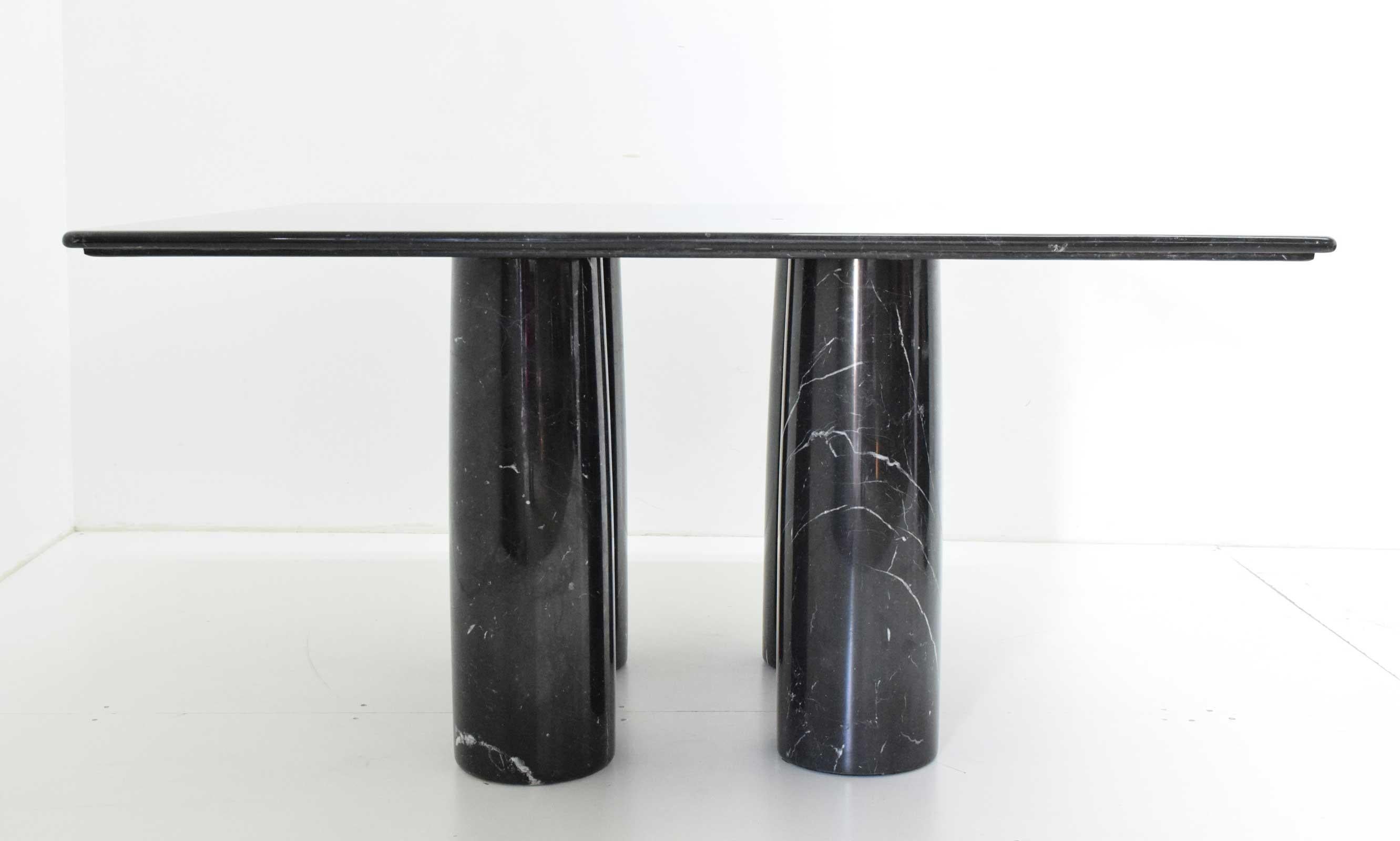 This monumental table by Milanese architect Mario Bellini is made purely from solid Nero Marquina marble.
The square top with a reversed step edge profile rests elegantly on four cylindrical columns that can be placed randomly.
For the 'Il