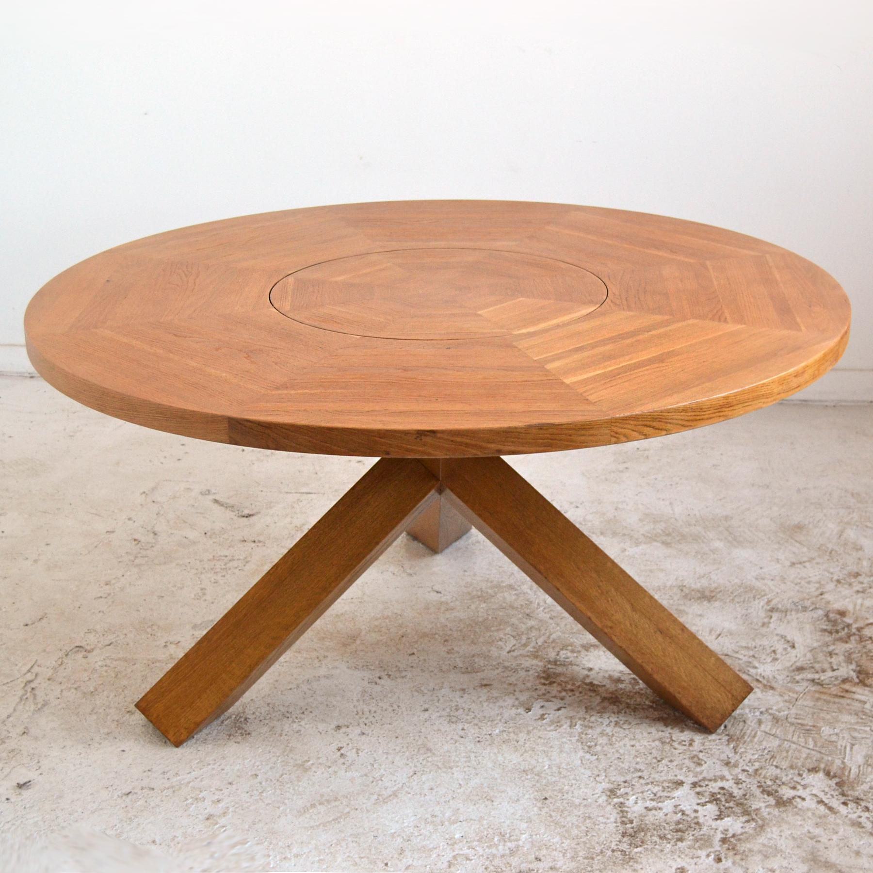 Crafted of solid oak, this large La Rotonda dining table designed in 1977 by Mario Bellini for Cassina has an uncommon and useful feature– a lazy susan built into the center of the top. The striking design has a jacks-form base which supports the