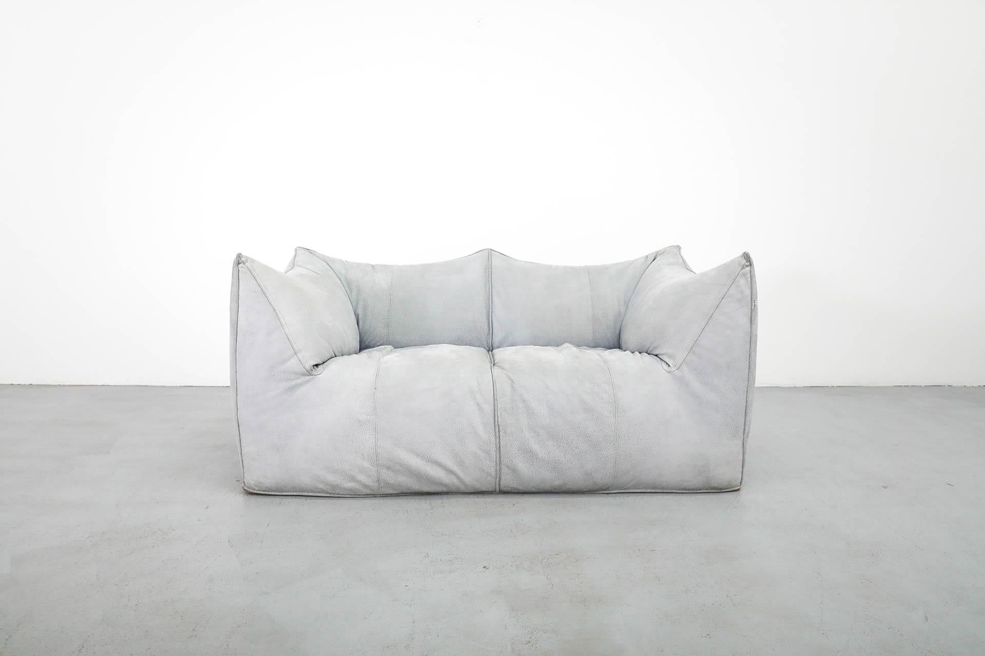 Mario Bellini for B&B Italia 'le Bambole' blue-grey suede loveseat. Iconic and distinctive soft form sofa with curved silhouette. In original condition with visible signs of wear including staining and some color fading. Wear is consistent with its