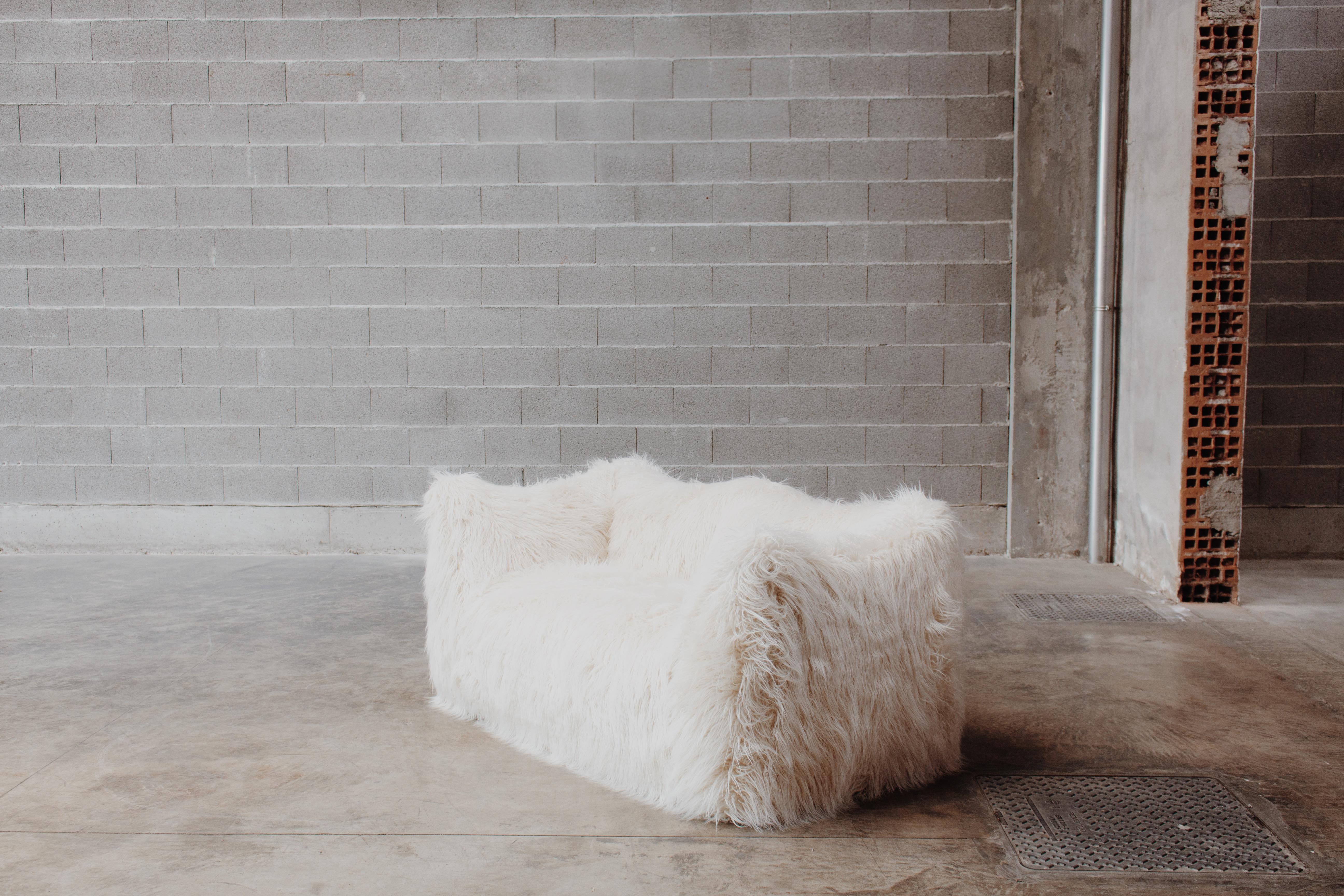 Mario Bellini “Le Bambole” two-seater sofa for B&B Italia, Mongolian faux-fur, Italy, 1971.

This is a timeless Postmodern design icon. The starting point was a shopping bag containing formless material shaped when the bag was set on the ground and
