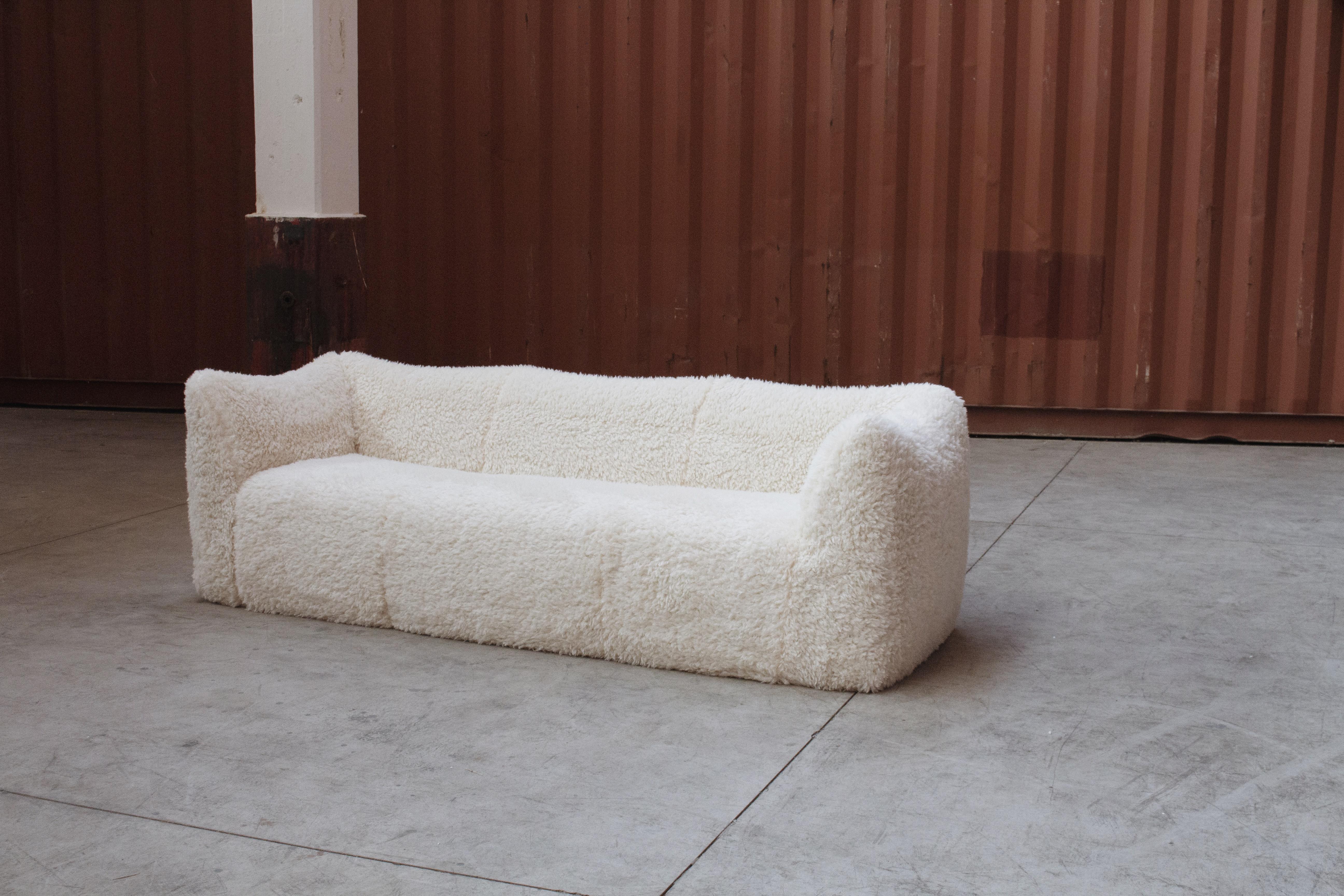 Mario Bellini “Le Bambole” three-seater sofa for B&B Italia, special edition in Mongolian sheepskin. 

The starting point was a shopping bag that contained formless material that was shaped when the bag was set on the ground and squashed. In the
