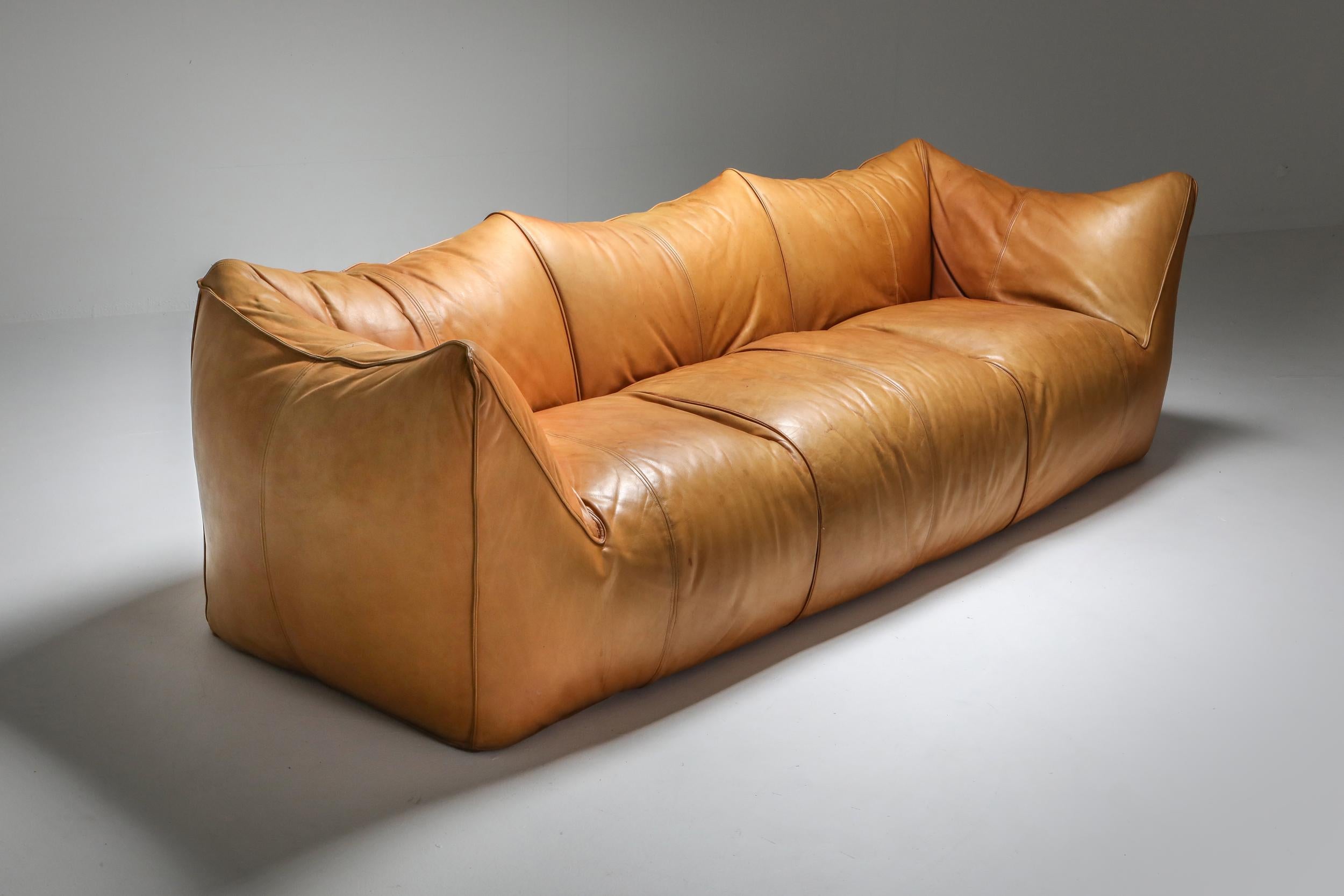'Le Bambole' by Mario Bellini, Italy, 1970s, cognac tan leather

The starting point was a shopping bag that contained formless material that was shaped when the bag was set on the ground and squashed. In the shared research undertaken by the