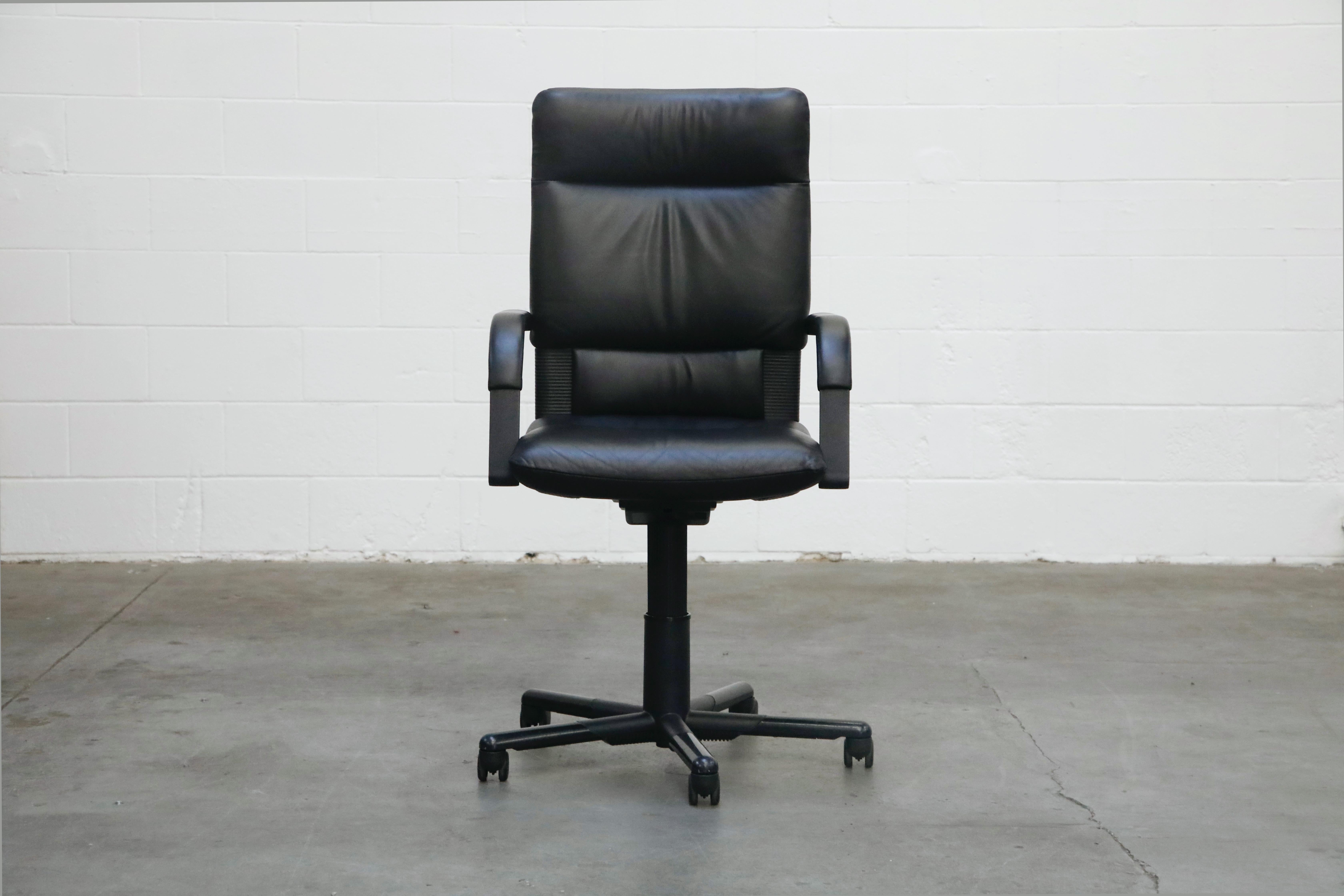 A spectacular example of a Mario Bellini signed highback executive desk chair for the Vitra, dated 1993 production. This Post Modern executive task chair features soft and supple black leather in excellent condition, five star height adjustable base