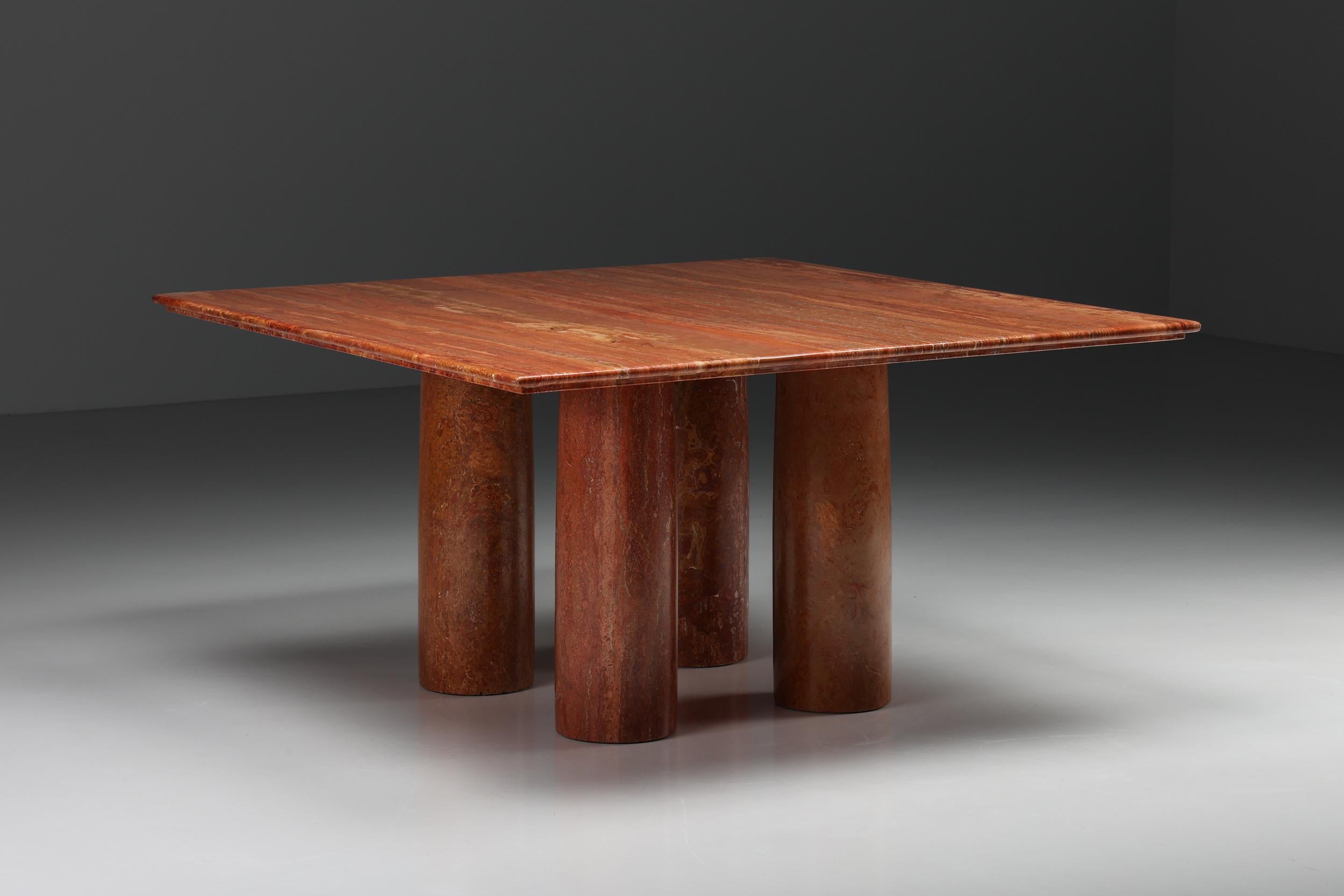 Mario Bellini 'Il Colonato' table, red travertine, Italy, 1970s.

For this series of tables, Bellini was inspired by ancient Roman columns. This table consists of four cylindrical legs and this model features a square tabletop. The red colored