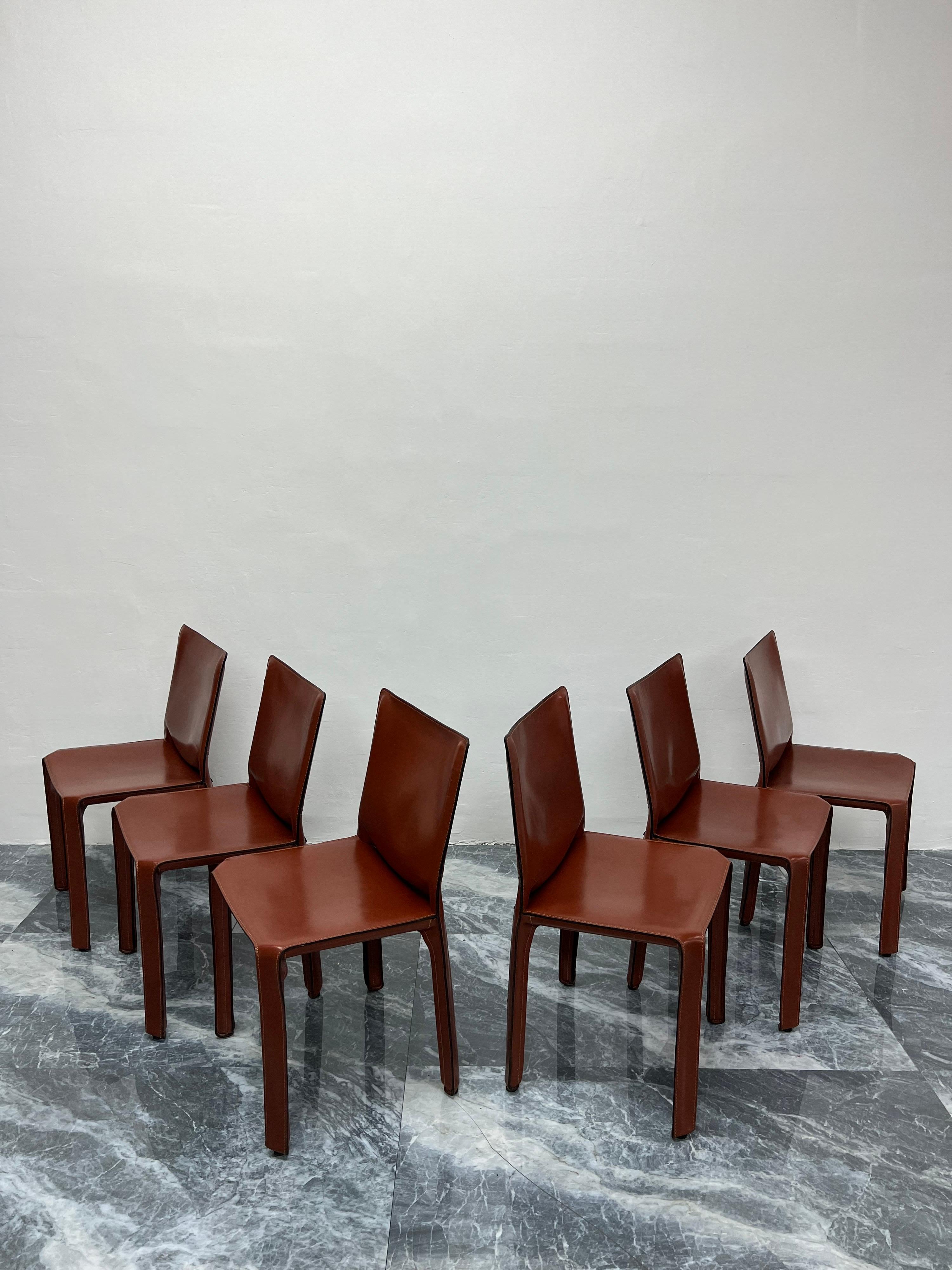 Set of six early production Cab 413 leather dining or side chairs designed by Mario Bellini for Cassina. Italy, 1970s. The leather more closely resembles burnt umber. Labeled and stamped in leather.

“This was a new kind of chair, constructed
