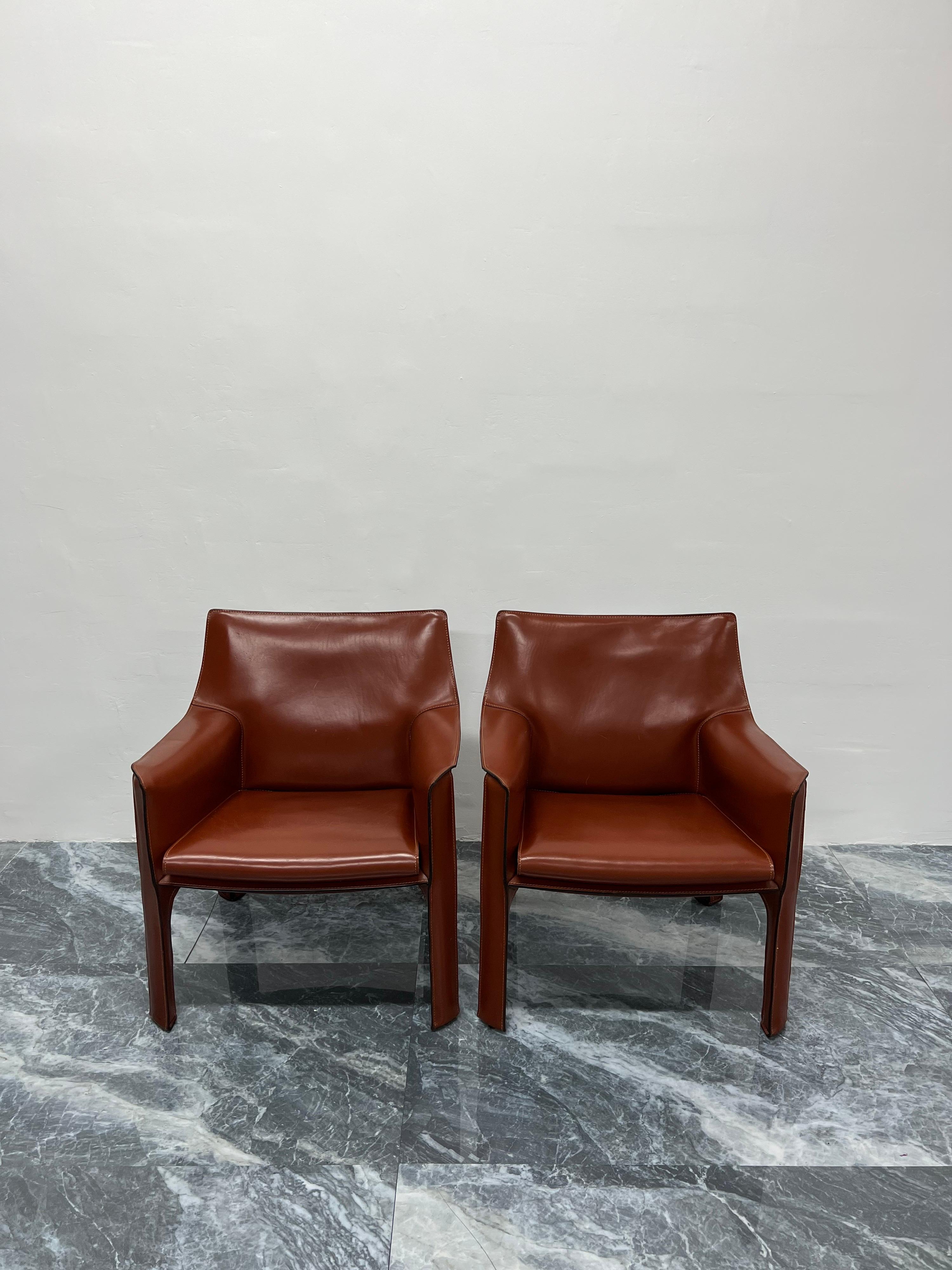 Pair of early production Cab leather lounge chairs with arms designed by Mario Bellini for Cassina. Italy, 1970s. The leather more closely resembles burnt umber. Labeled and stamped in leather.

“This was a new kind of chair, constructed totally out