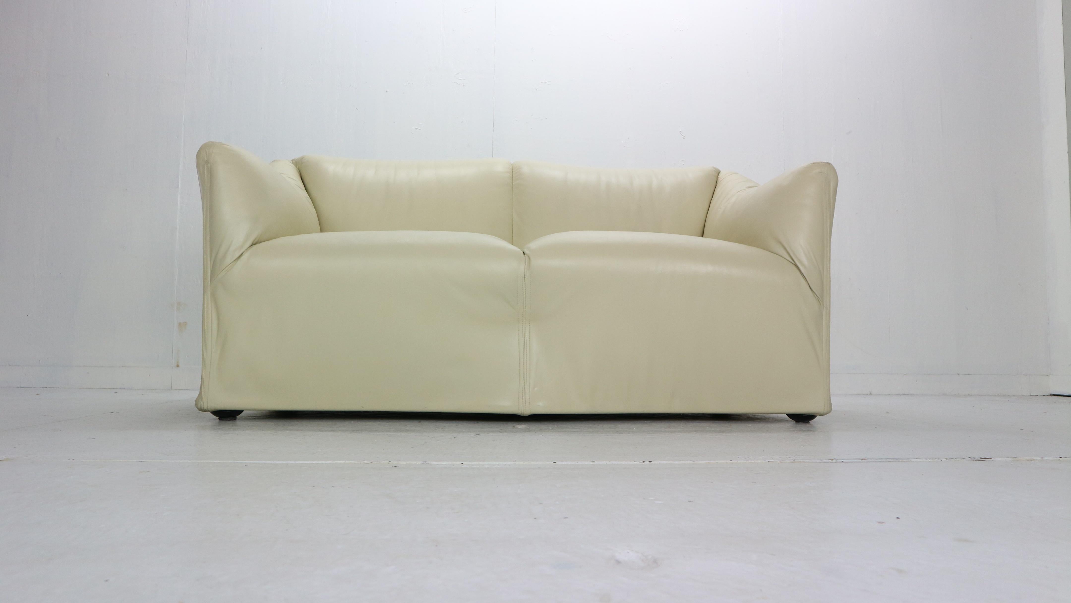This lounge two-seat sofa or loveseat designed by Mario Bellini for Cassina manufacture in 1970s period, Italy.
Model No: 685,
Creme color leather original upholstery, steel frame construction on casters.

Tentazione means temptation an inviting