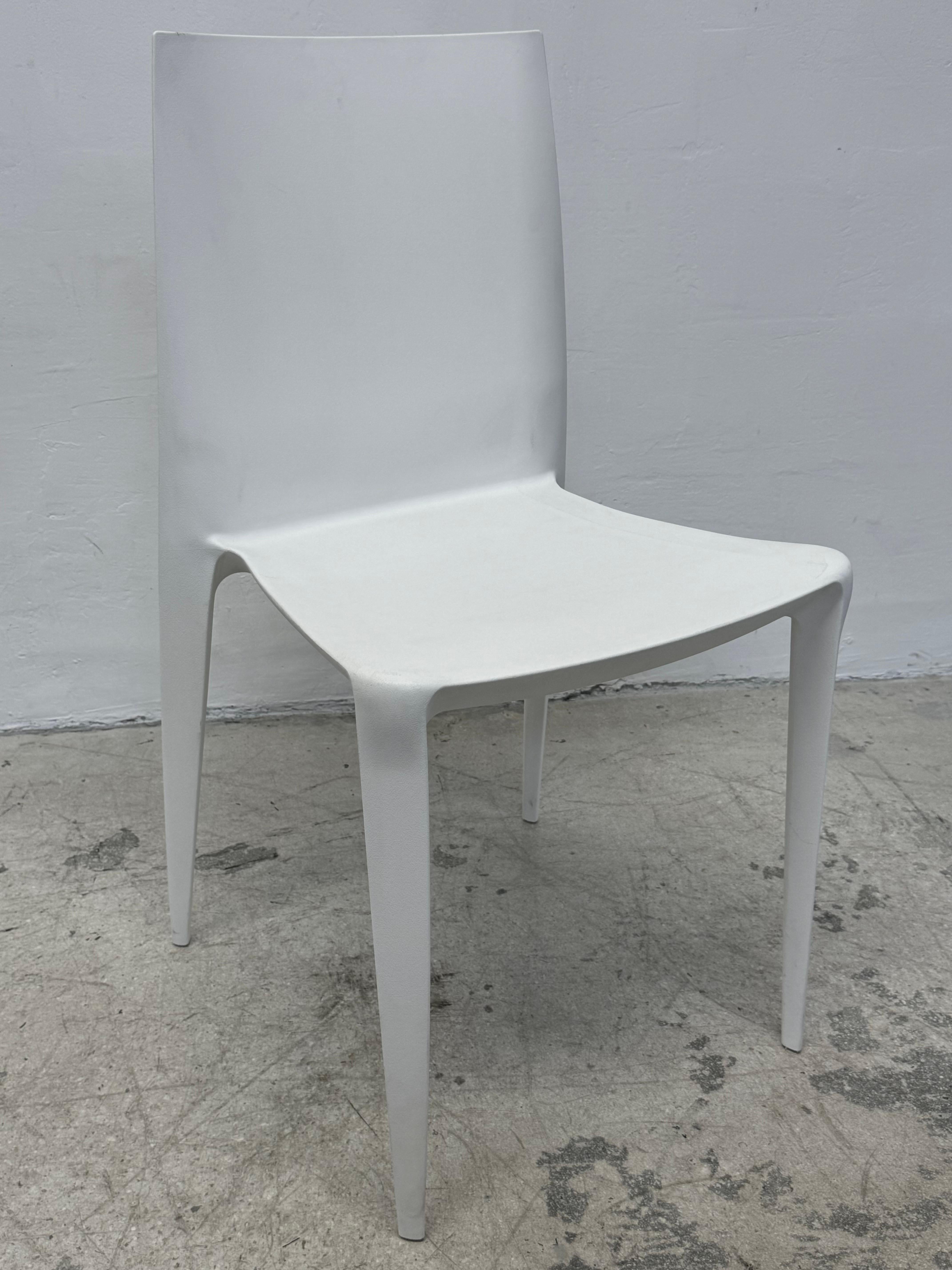 Five white plastic The Bellini Chairs by Mario Bellini for Heller.  

Designed by the versatile architect Mario Bellini, celebrated for his distinctive designs in architecture, master planning, interiors, furnishings, and industrial design, the