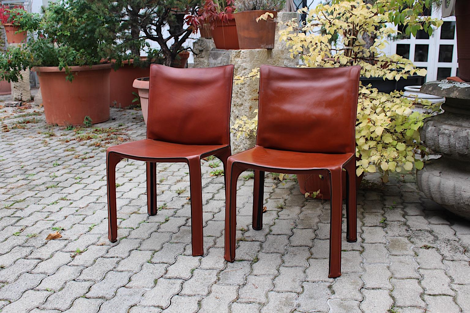 Mario Bellini duo pair two (2) vintage dining chairs or side chairs model CAB 412
from cognac brown leather designed 1970s, Italy.
A timeless and sleek modern design icon, the CAB chair 412 by Mario Bellini from stitched thick leather in stunning