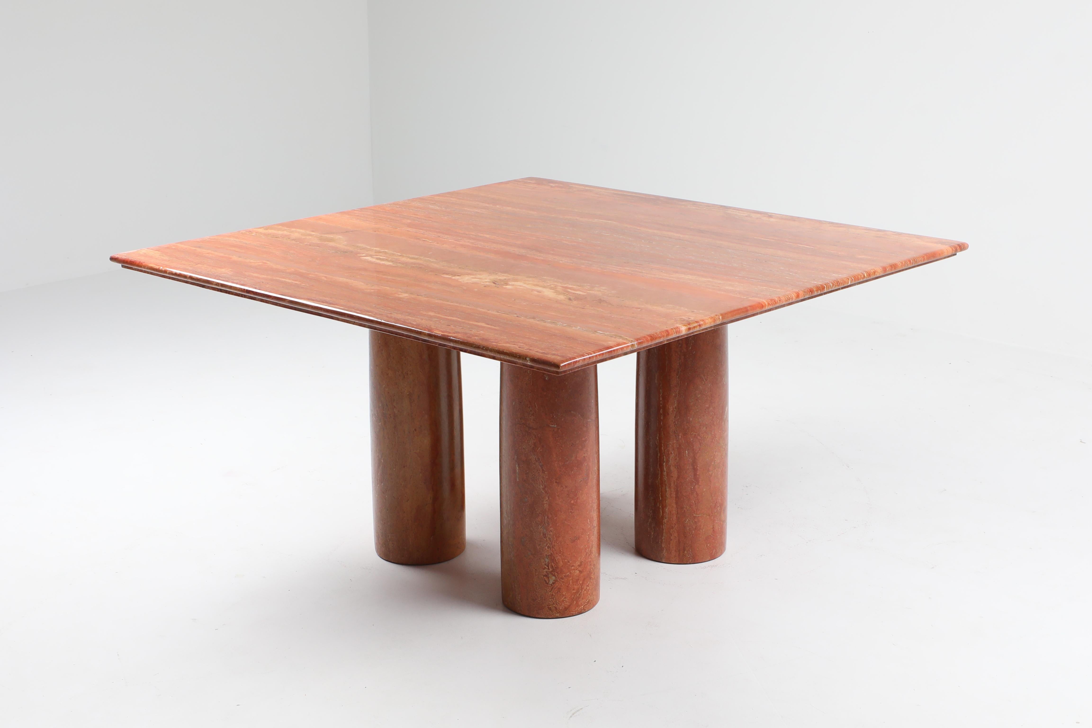 Mario Bellini 'Il Colonato' table, red travertine, Italy, 1970s.

For this series of tables, Bellini was inspired by ancient Roman columns. This table consists of four cylindrical legs and this model features a square tabletop. The red colored