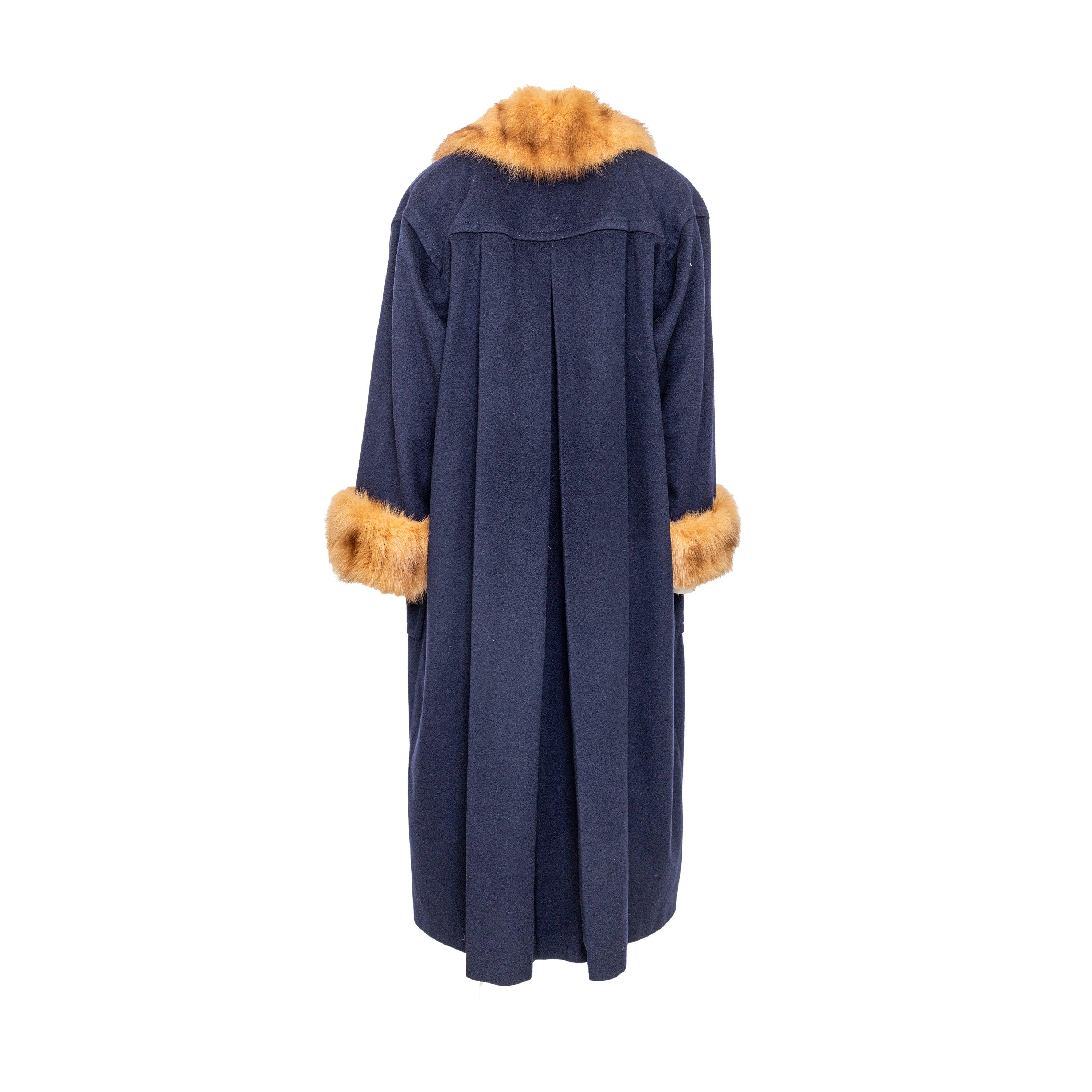 Stay warm and stylish in the Mario Borsato Wool Coat with Fur. Made from a luxurious blue wool blend, this vintage coat features brown fur trimmings and a pleated back for added volume. Keep your hands cozy with two convenient front pockets.
