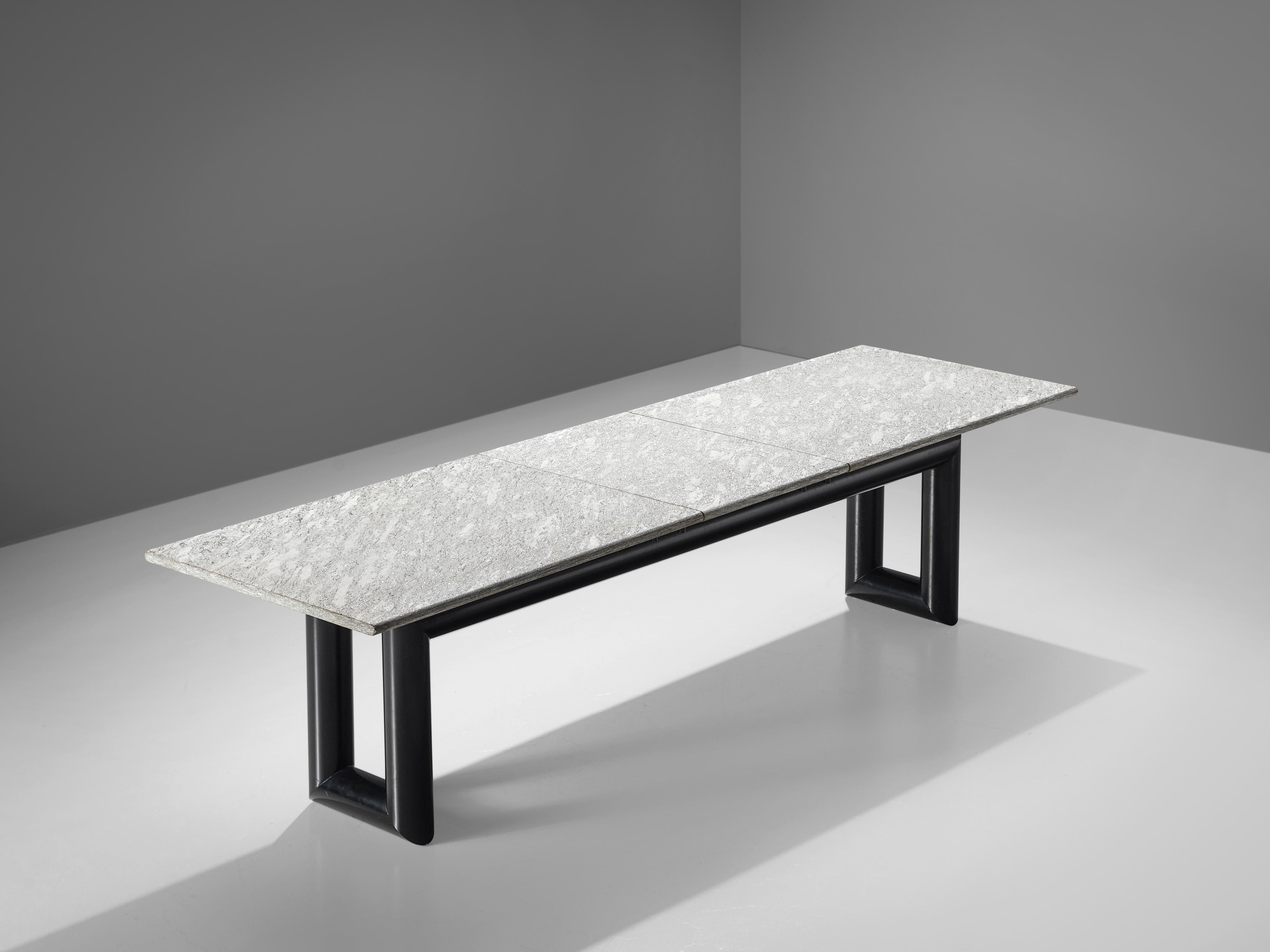 Mario Botta for Alias, dining table model ‘Terzo’, metal, granite, Italy, 1983
 
The ‘Terzo’ dining table features a long rectangular granite tabletop that consists of three parts and shows a beautiful sparkle and a play of different color shaded