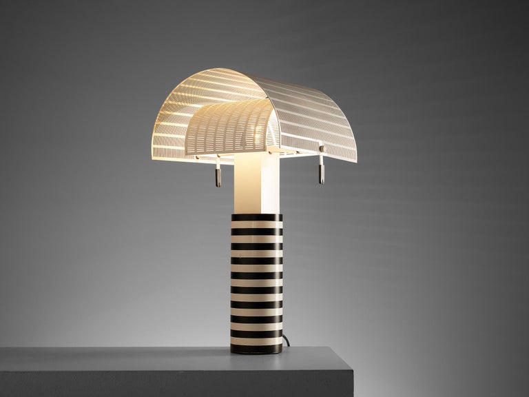 Mario Botta for Artemide, 'Shogun' table lamp, metal, Italy, 1986 

Mario Botta referred to lamps as “people”. He said “Shogun is a person. He has a head, body and feet, plus he has a navel.” The designer is known for his use of geometric forms