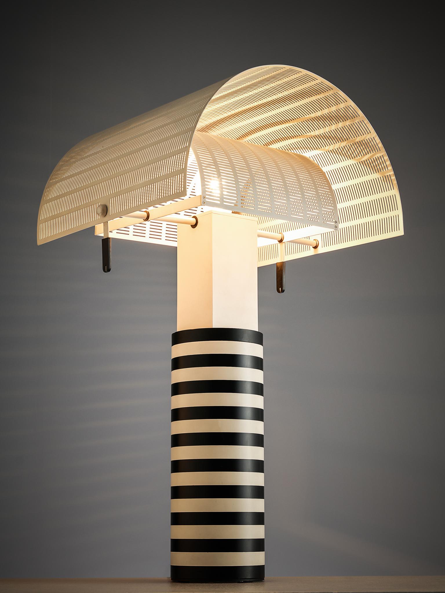 Mario Botta for Artemide, 'Shogun' table lamp, metal, Italy, 1986.

A post Modern table lamp by Mario Botta. The cylindrical shaft is coated in black and white stripes. Two semi-circled, perforated diffusers can be adjusted to create variations of