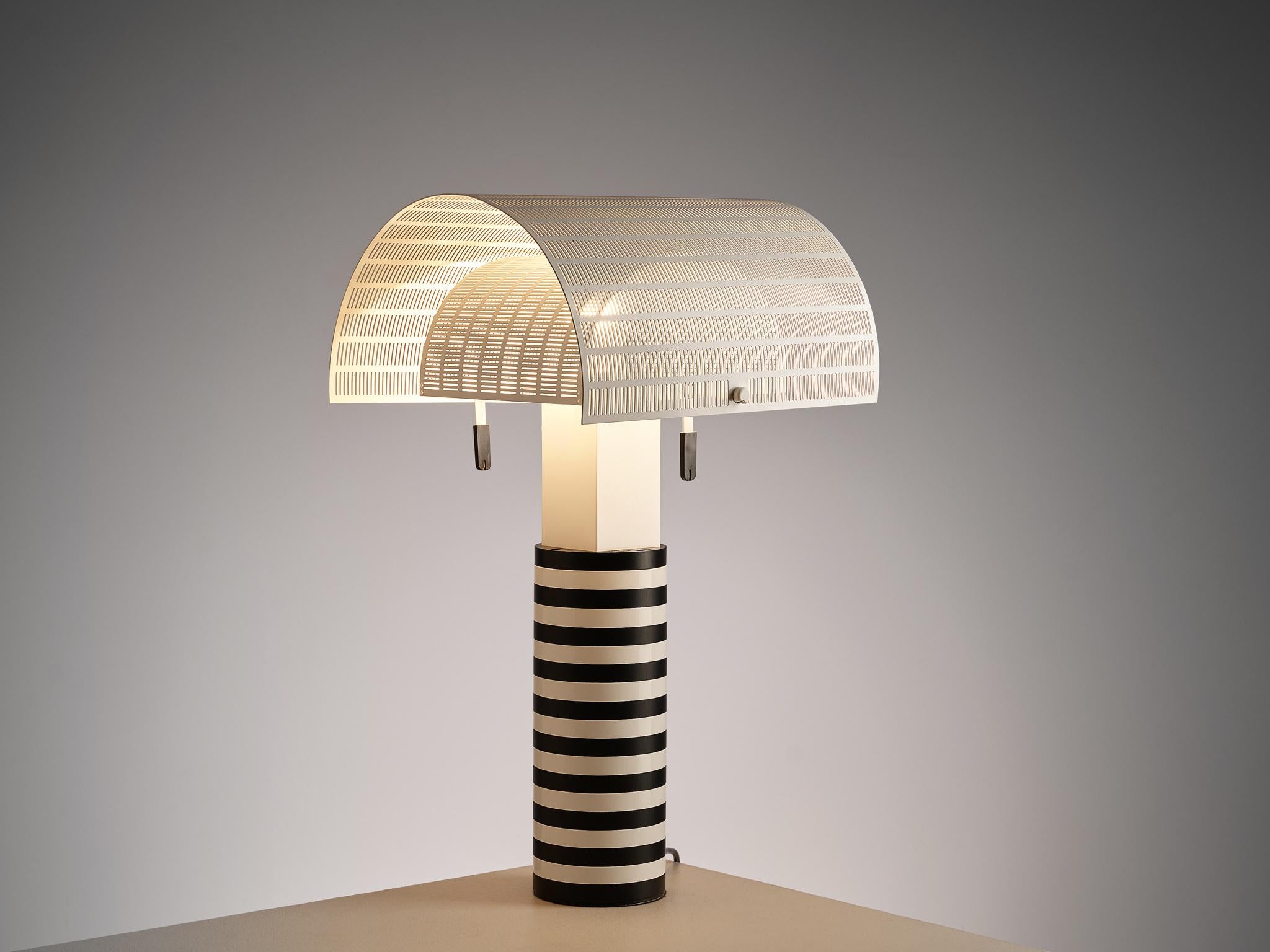 Mario Botta for Artemide, 'Shogun' table lamp, metal, Italy, 1986

A post modern table lamp by Mario Botta for Artemide. The cylindrical shaft is coated in black and white stripes. Two semi-circled, perforated diffusers can be adjusted to create