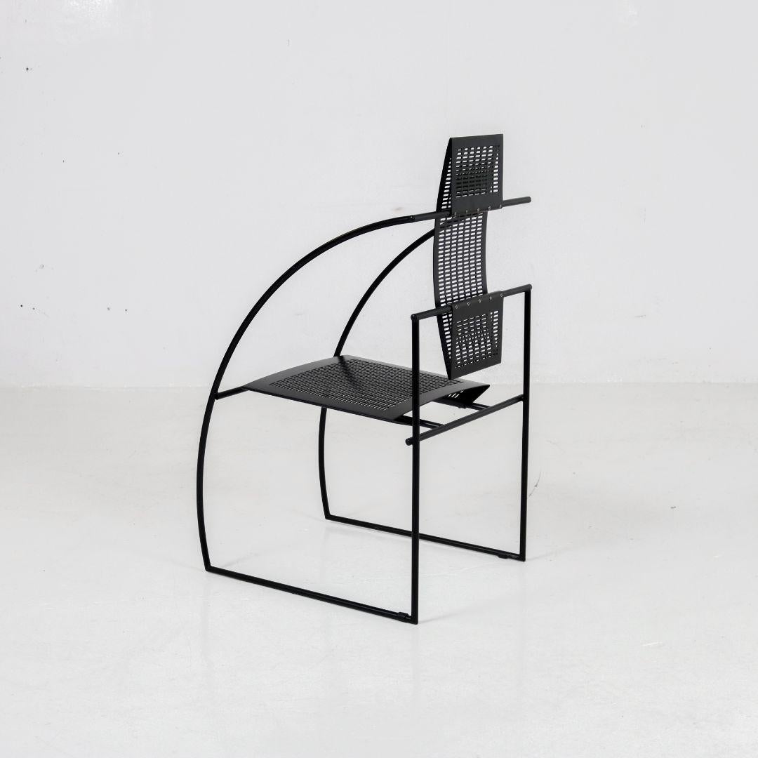 Iconic 'Quinta' chair designed by Mario Botta for Alias. This sculptural masterpiece, dating back to the 1980s, has earned a place of honor in the permanent collection of the MoMA in New York. The chair is made of black lacquered metal and is in