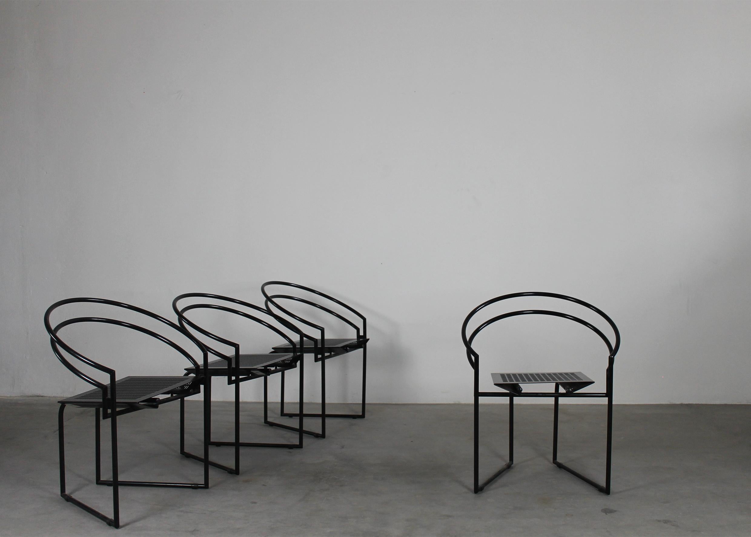 Set of four dining chairs 614 or La Tonda with a black lacquered steel rod frame, seats and backs in bent perforated sheet metal.
Designed by Mario Botta for Alias 1980s Italy. 

Mario Botta was born in 1943 in Mendrisio. After working as an