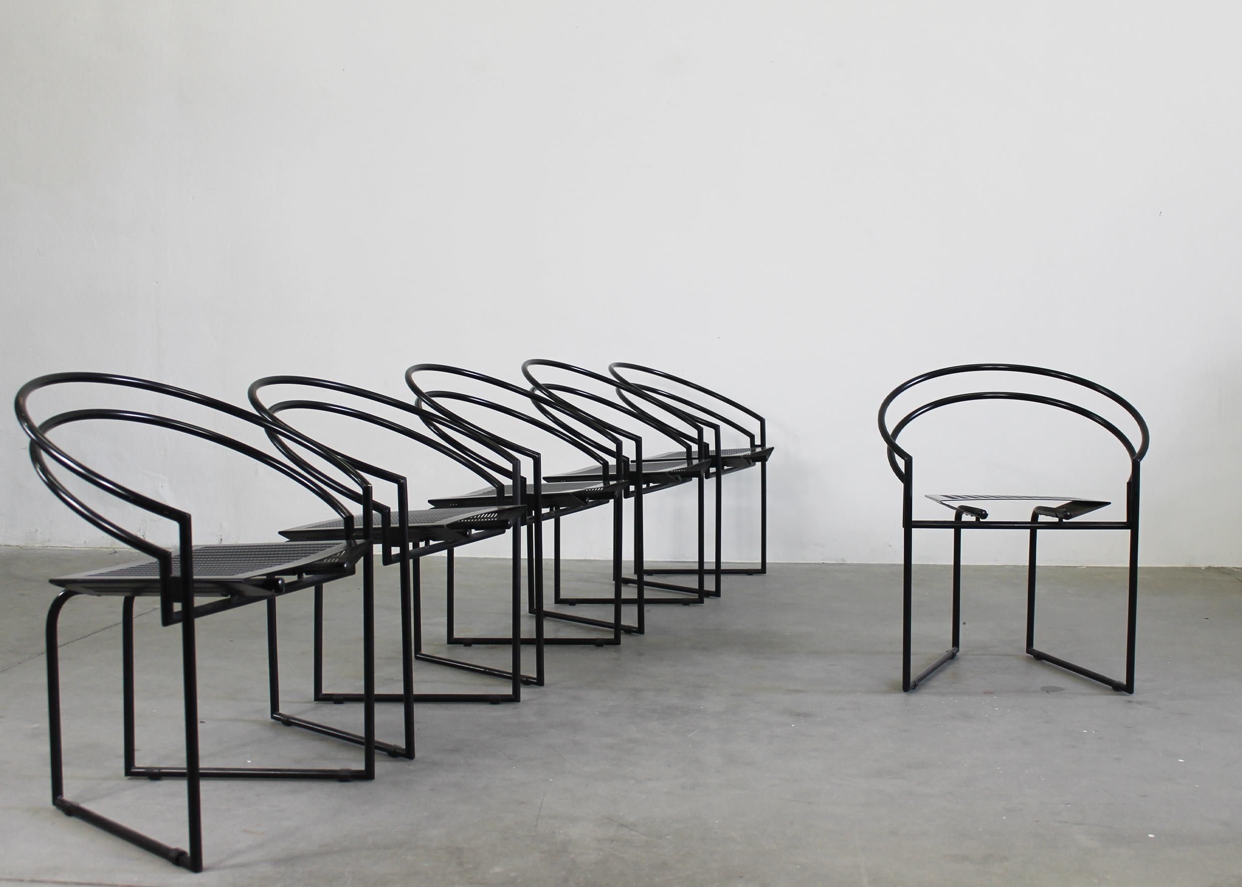 Set of six 614 or La Tonda chairs in black lacquered tubular metal frame with seats in black lacquered perforated sheet metal, designed by Mario Botta and produced by Alias in 1980s.

The manufacturer's label is visible on the chair's frame, under