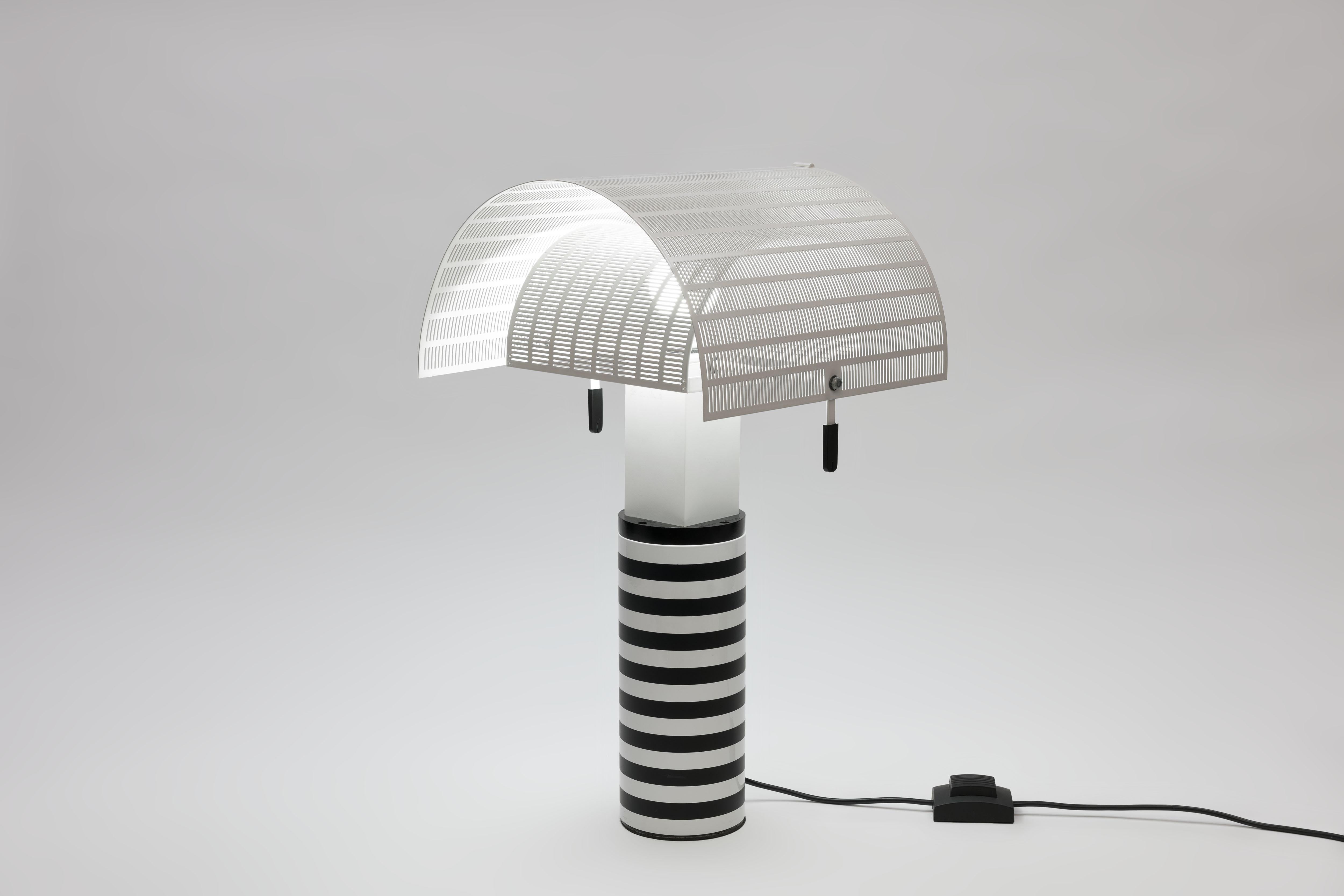 Iconic 'Shogun' lamp by Swiss-Italian Architect Mario Botta. Signature black and white striped base with pivoting, slit-perforated white steel shade.
This execution is from the early 1990ies and comes in exceptional good and clean condition.
One