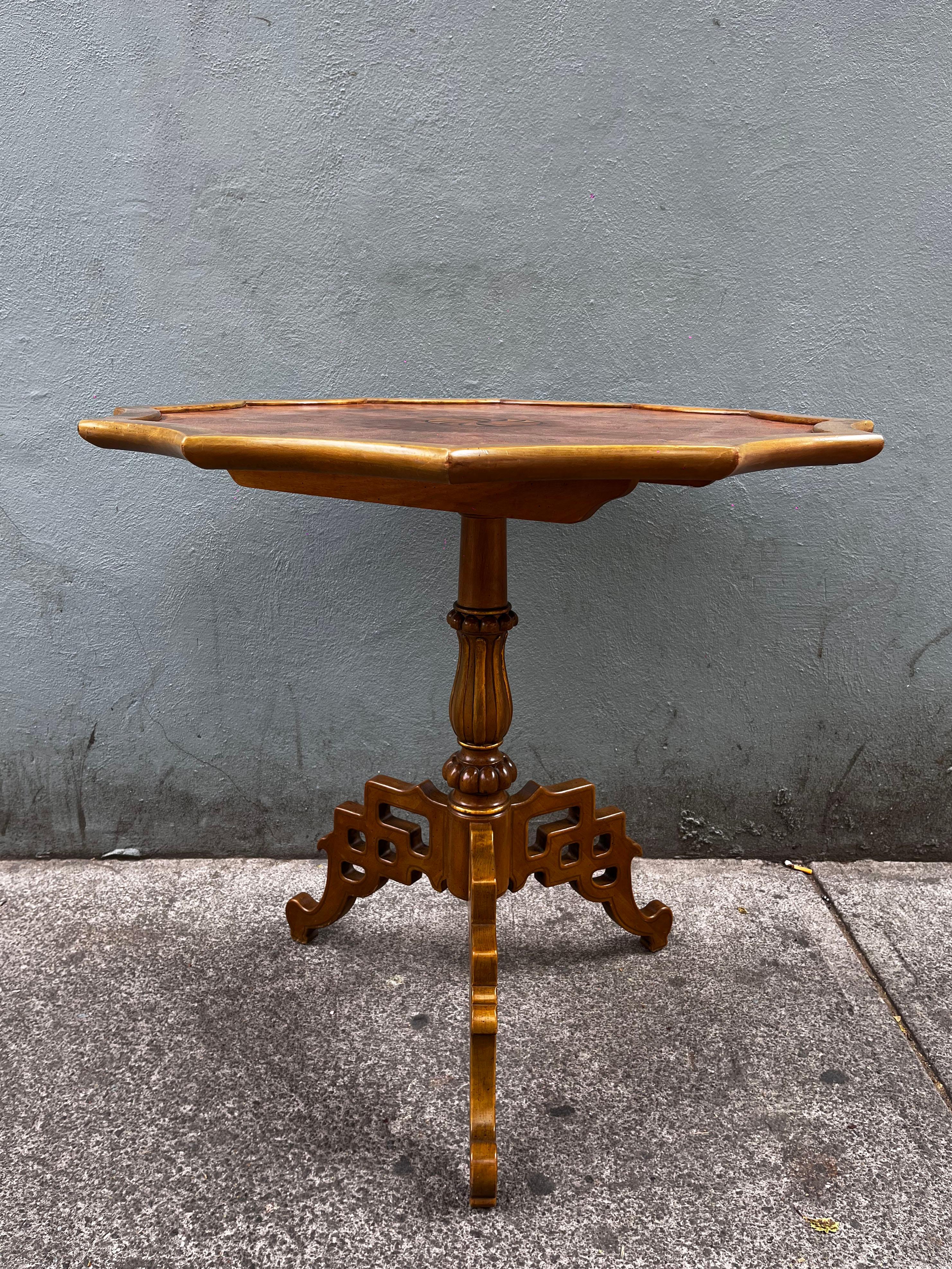 A 1970's burlwood tea table with chinoisserie base by American designer Mario Buatta. Manufactured by John Widdicomb as part of their Mario Buatta Collection. The dodecagonal top has his sides rounded, burlwood veneer and shows a parquetry round