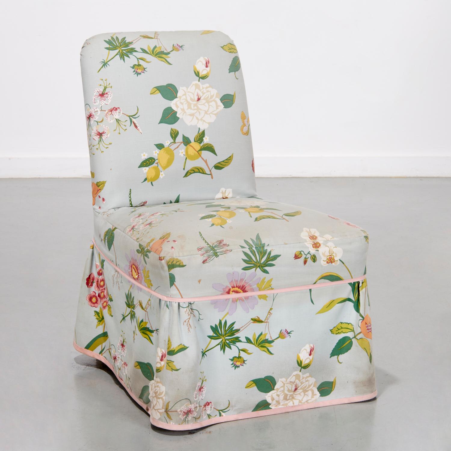 20th c., American, a floral print linen slipcover over a vintage chair. A beautiful Buatta fabric slipcover with flora, fauna and dragonflies on a duck egg blue ground. The seat and skirt are trimmed in a blush pink fabric. Beneath the tailored